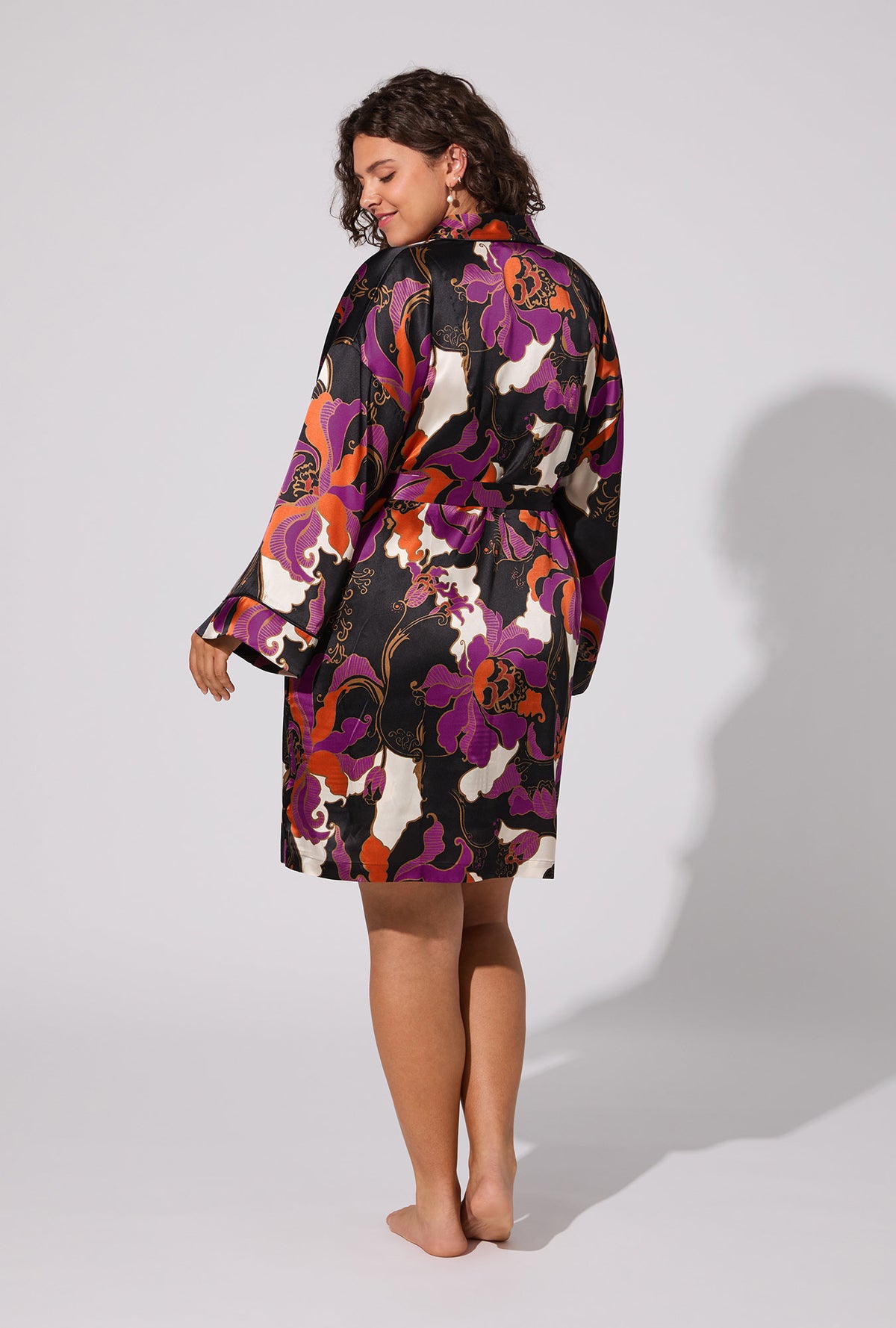 A lady wearing BedHead X Trina Turk Fall Floral Banded Collar Washable Silk Robe
