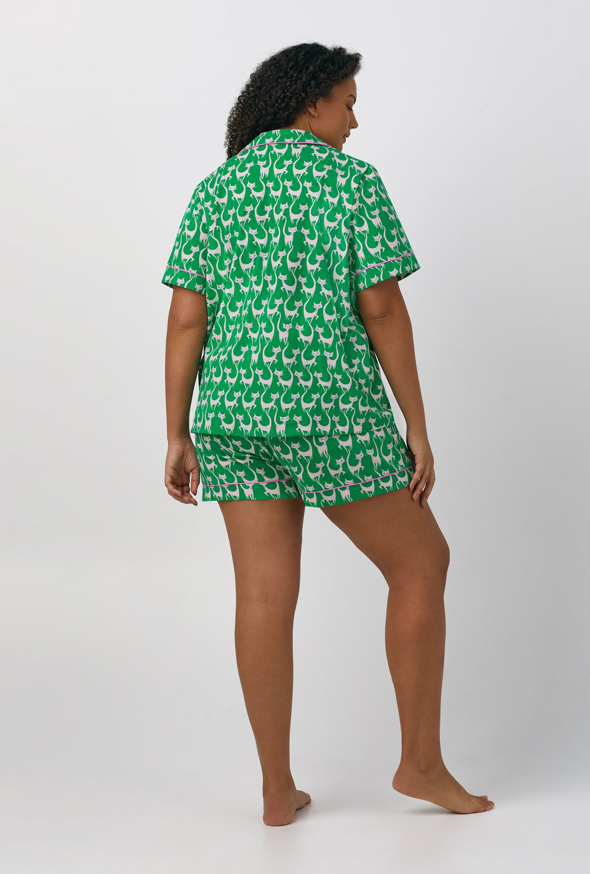 A lady wearing plus size green Short Sleeve Classic Shorty Stretch Jersey PJ Set with Cool Cats print