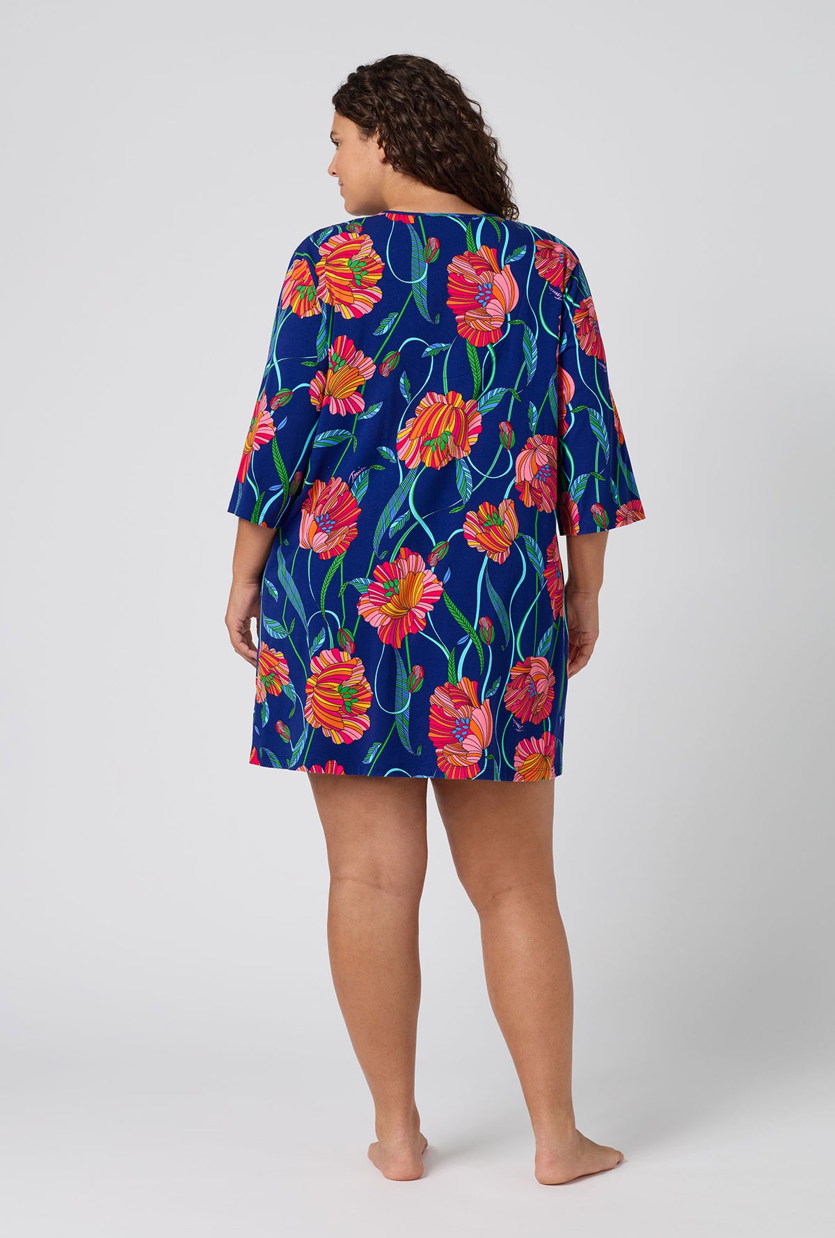 A Lady Wearing Plus Size BedHead x Trina Turk Linear Poppy Stretch Jersey Sleep Dress in a back view pose