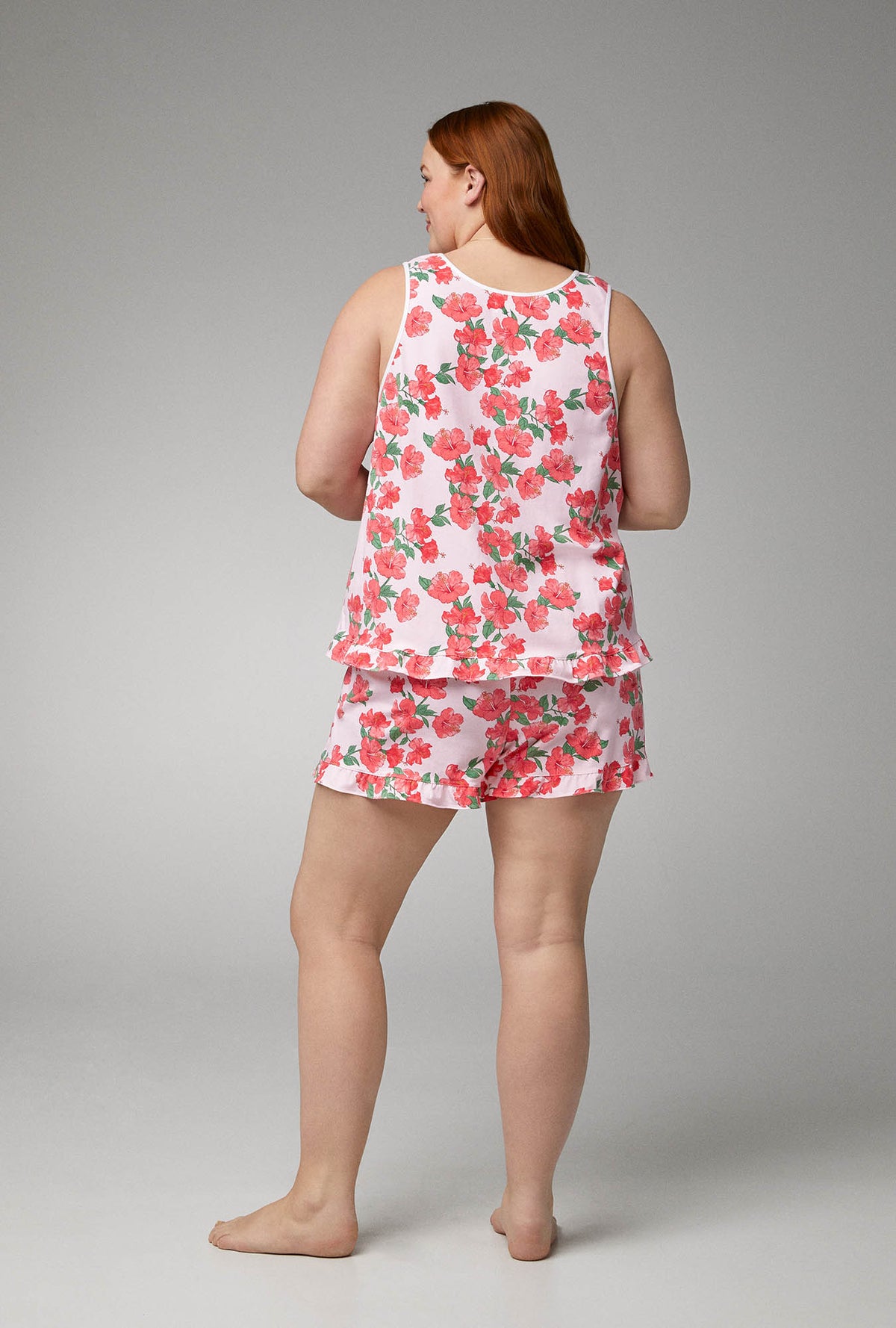 A lady wearing Ruffle Tank Shorty Stretch Jersey PJ Set with Sweet Hibiscus print