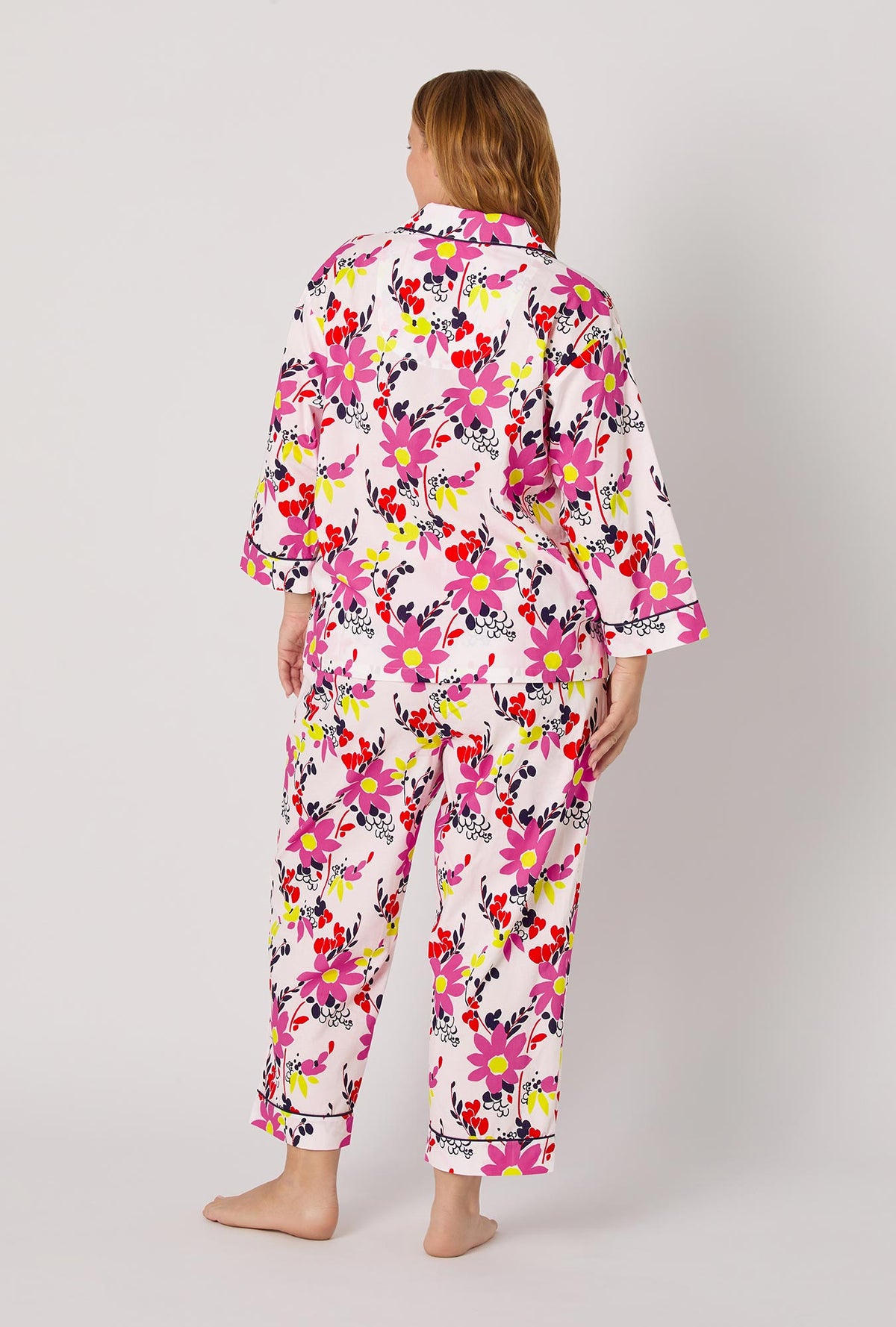 A lady wearing BedHead x Trina Turk Whimsical Floral 3/4 Sleeve Classic Woven Cotton Cropped Pj Set
