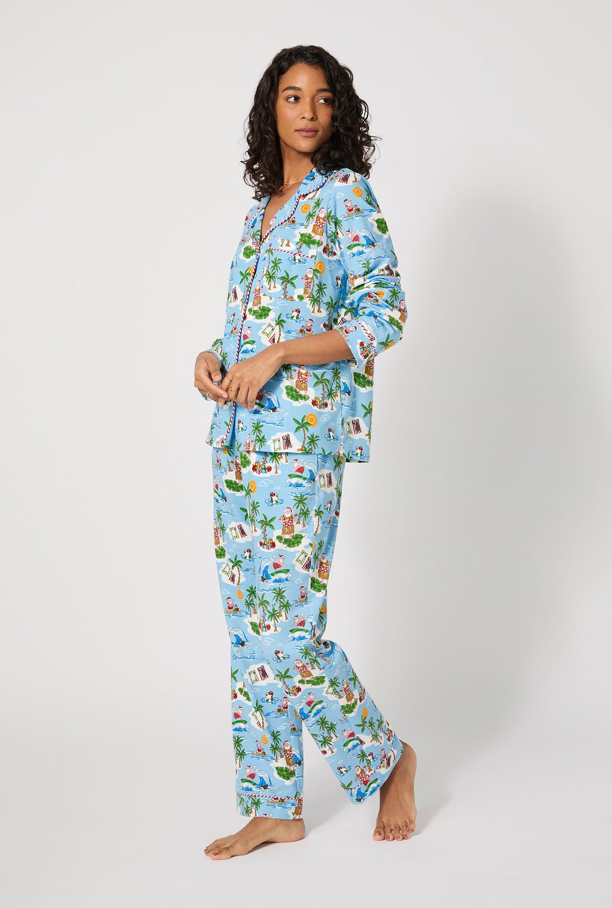 A lady wearing Surfin&#39; Santa Long Sleeve Classic Stretch Jersey Pj Set