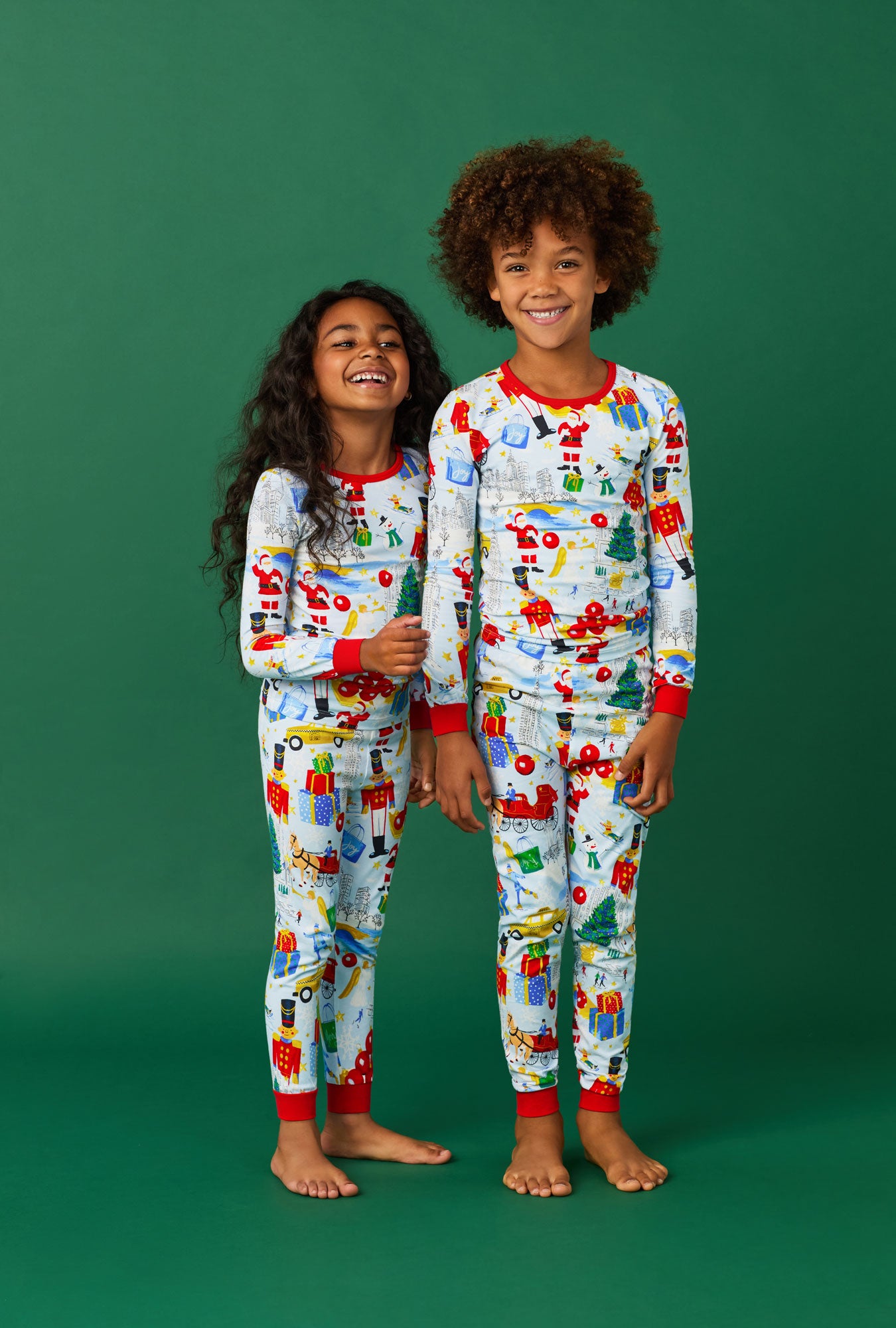 A girl and a boy wearing A City Christmas Long Sleeve Stretch Jersey Kids Pj Set