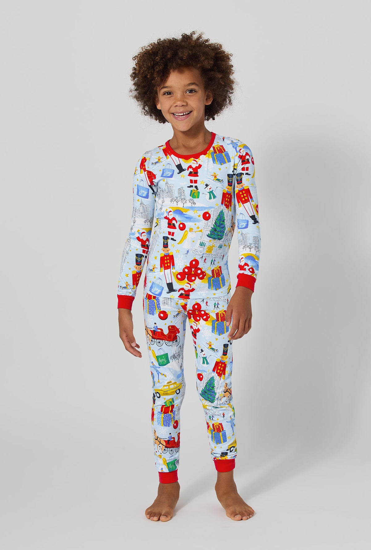 A boy wearing A City Christmas Long Sleeve Stretch Jersey Kids Pj Set