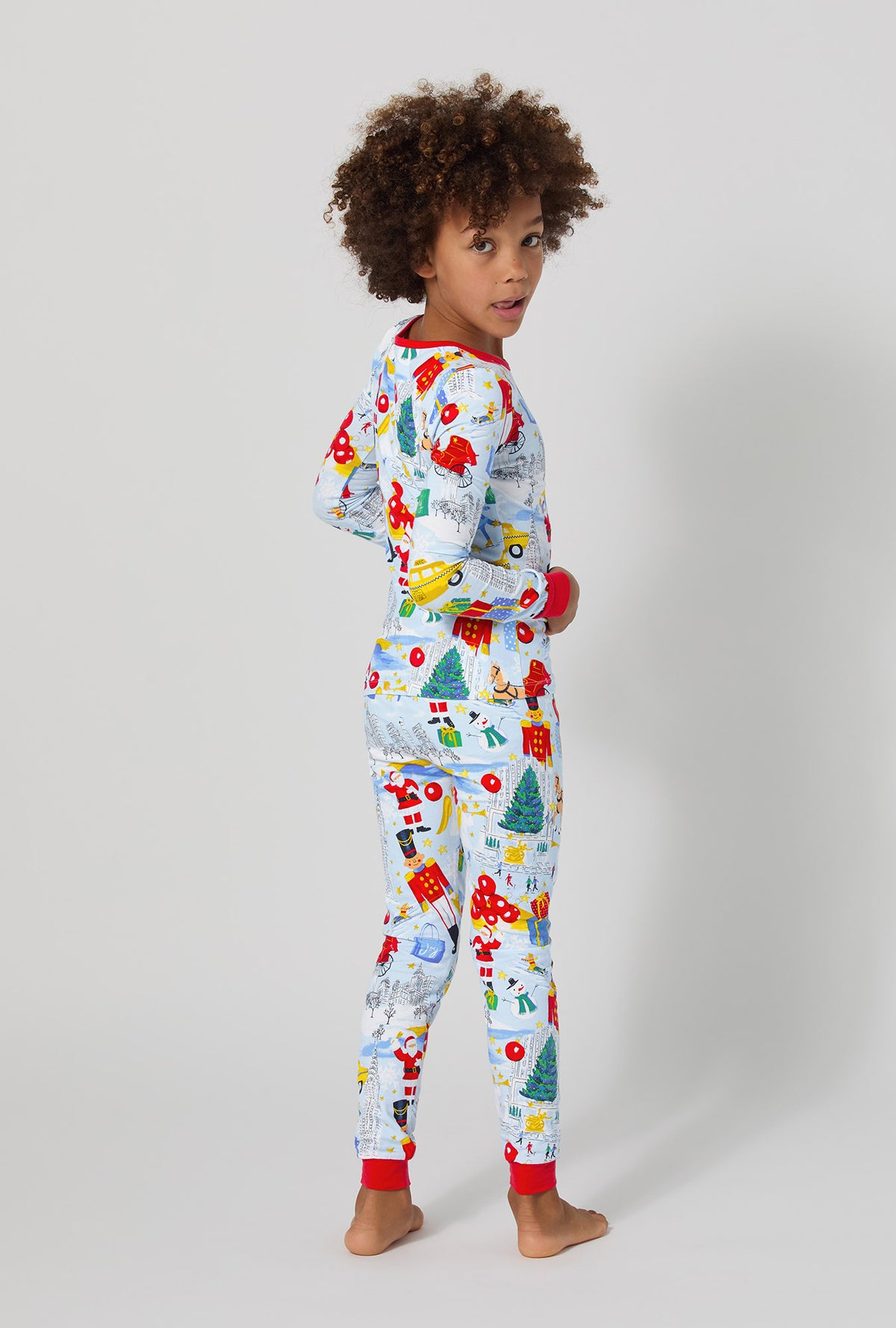 A boy wearing A City Christmas Long Sleeve Stretch Jersey Kids Pj Set