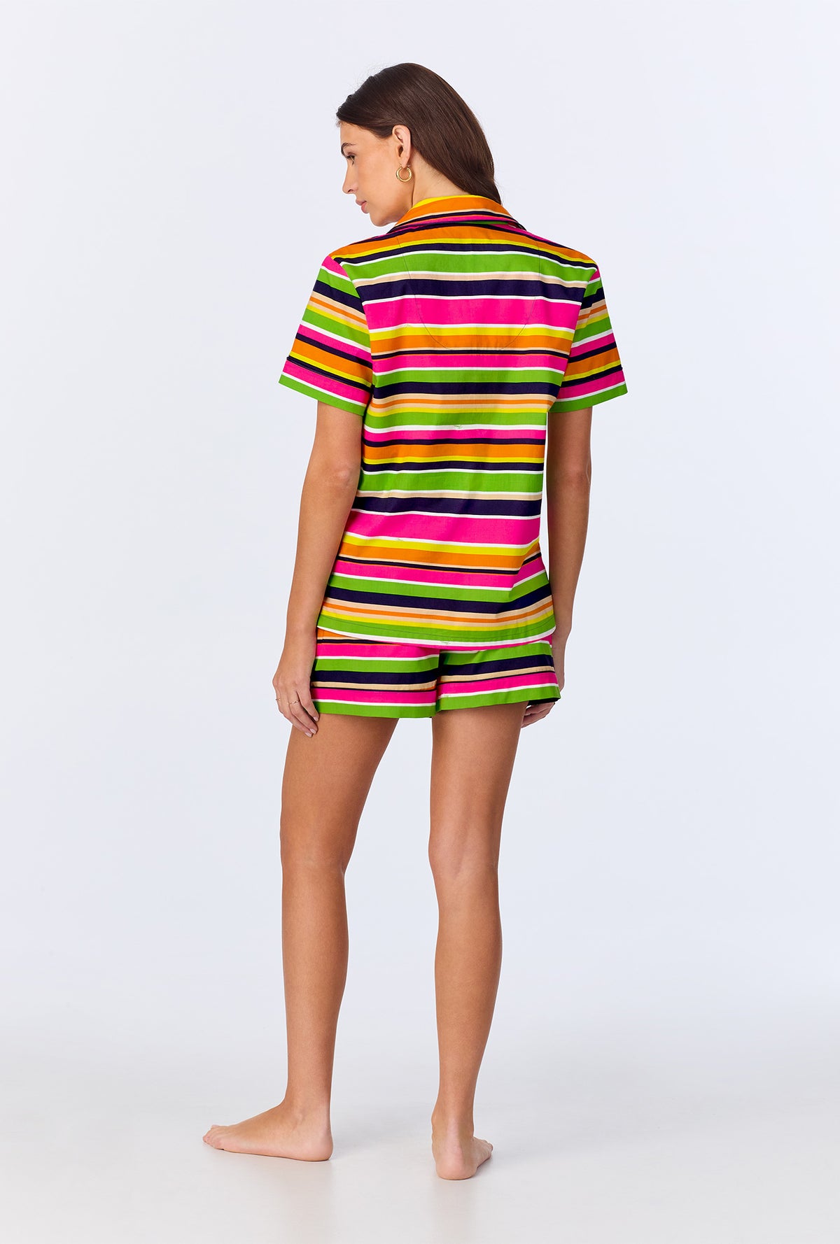 A lady wearing BedHead x Trina Turk Poolside Stripe Short Sleeve Classic Woven Cotton Poplin Shorty PJ Set