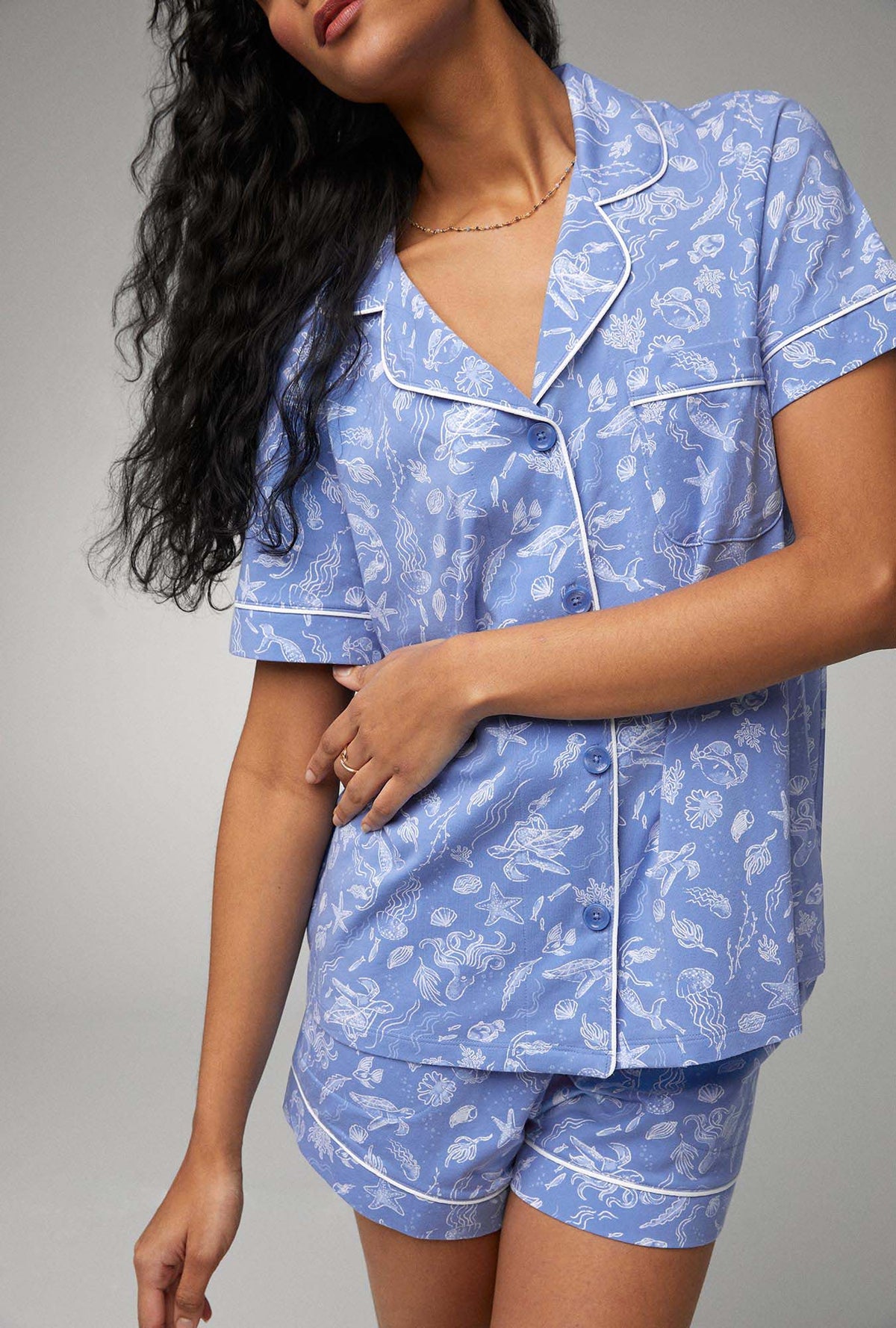 A lady wearing blue short sleeve classic shorty stretch jersey pj set with high tide print.
