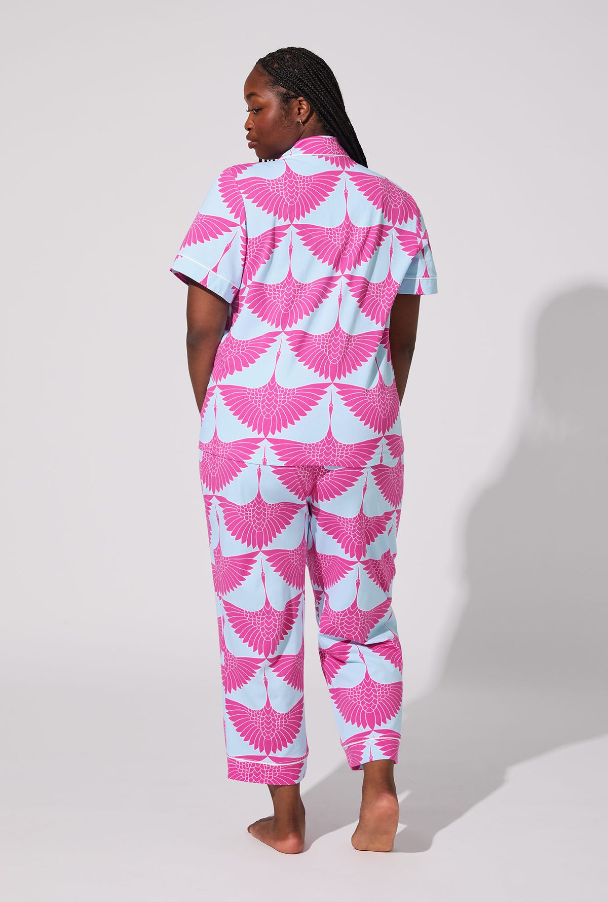 A lady wearing BedHead X Trina Turk Cranes Short Sleeve Classic Stretch Jersey Cropped PJ Set