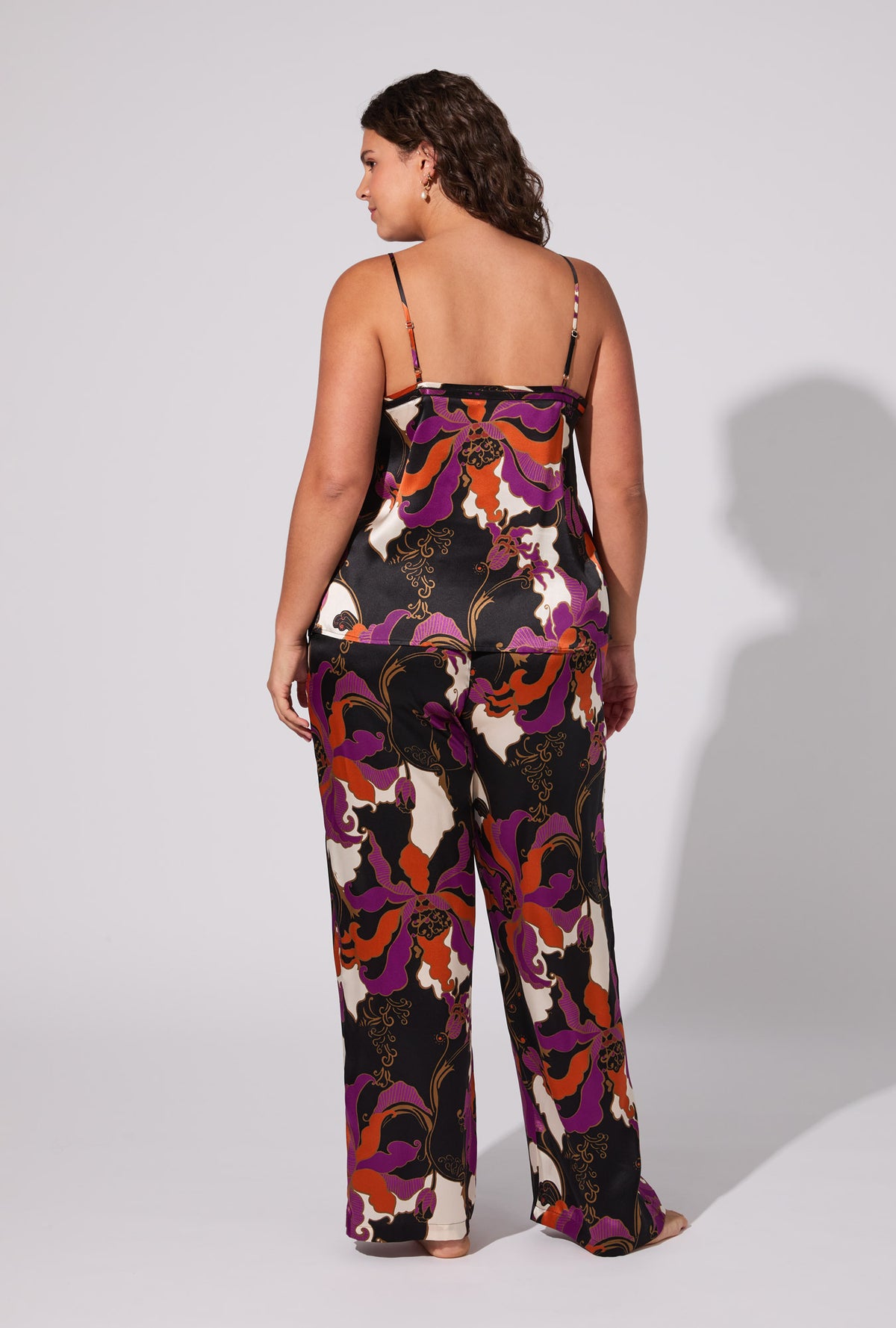 A lady wearing BedHead X Trina Turk Fall Floral Cami Tank Woven Washable Silk Long PJ Set