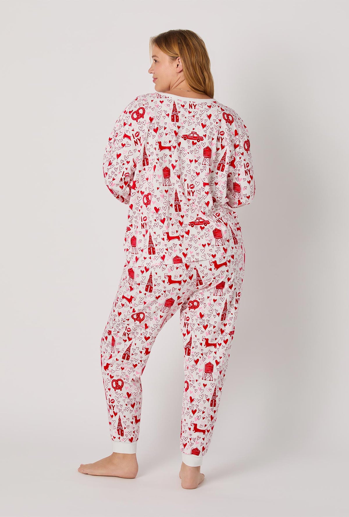 A lady wearing Heart Of The City Long Sleeve Pullover Crew And Jogger Stretch Jersey Pj Set