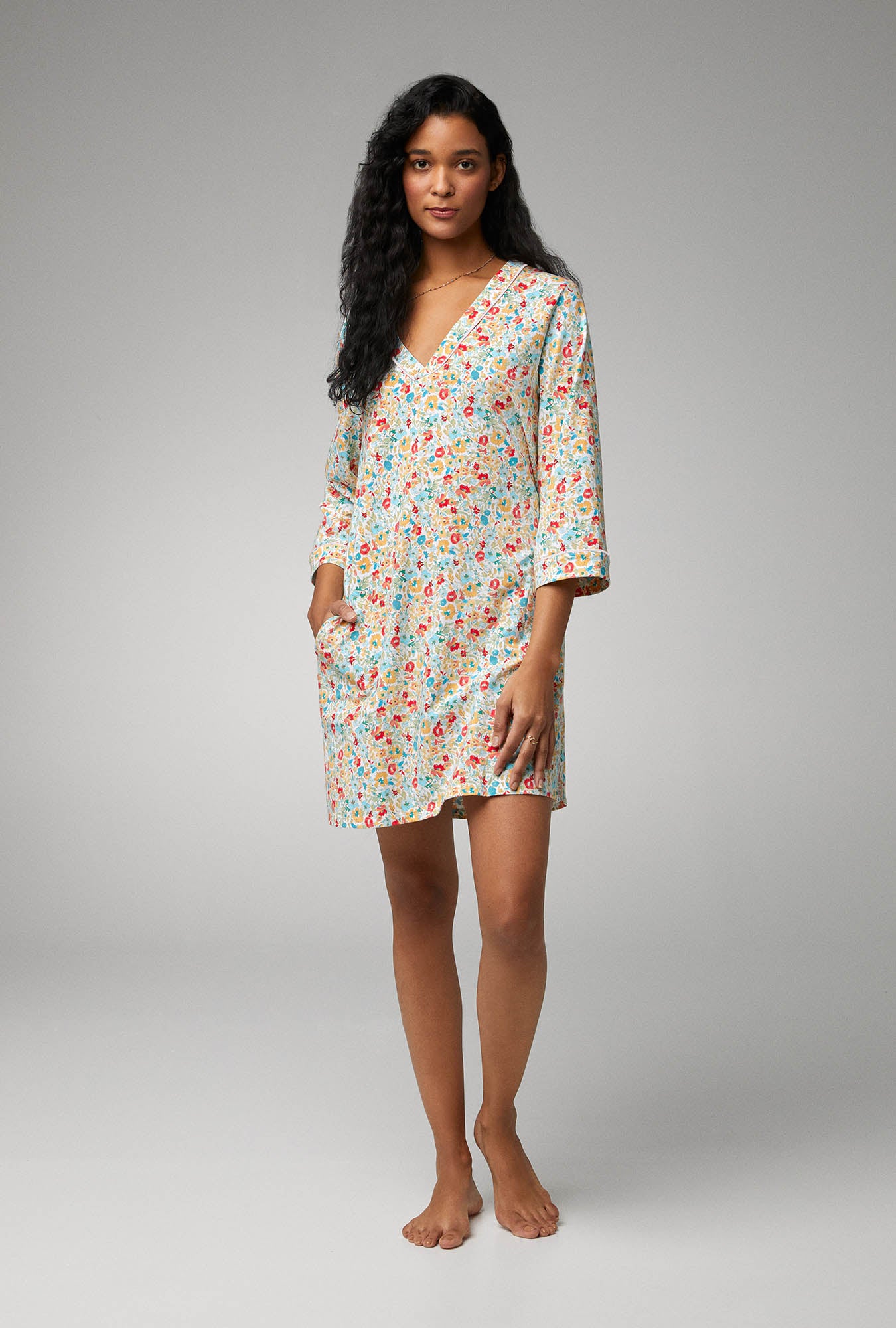 A lady wearing multi color quarter sleeve stretch jersey sleepshirt with inflorescence print.