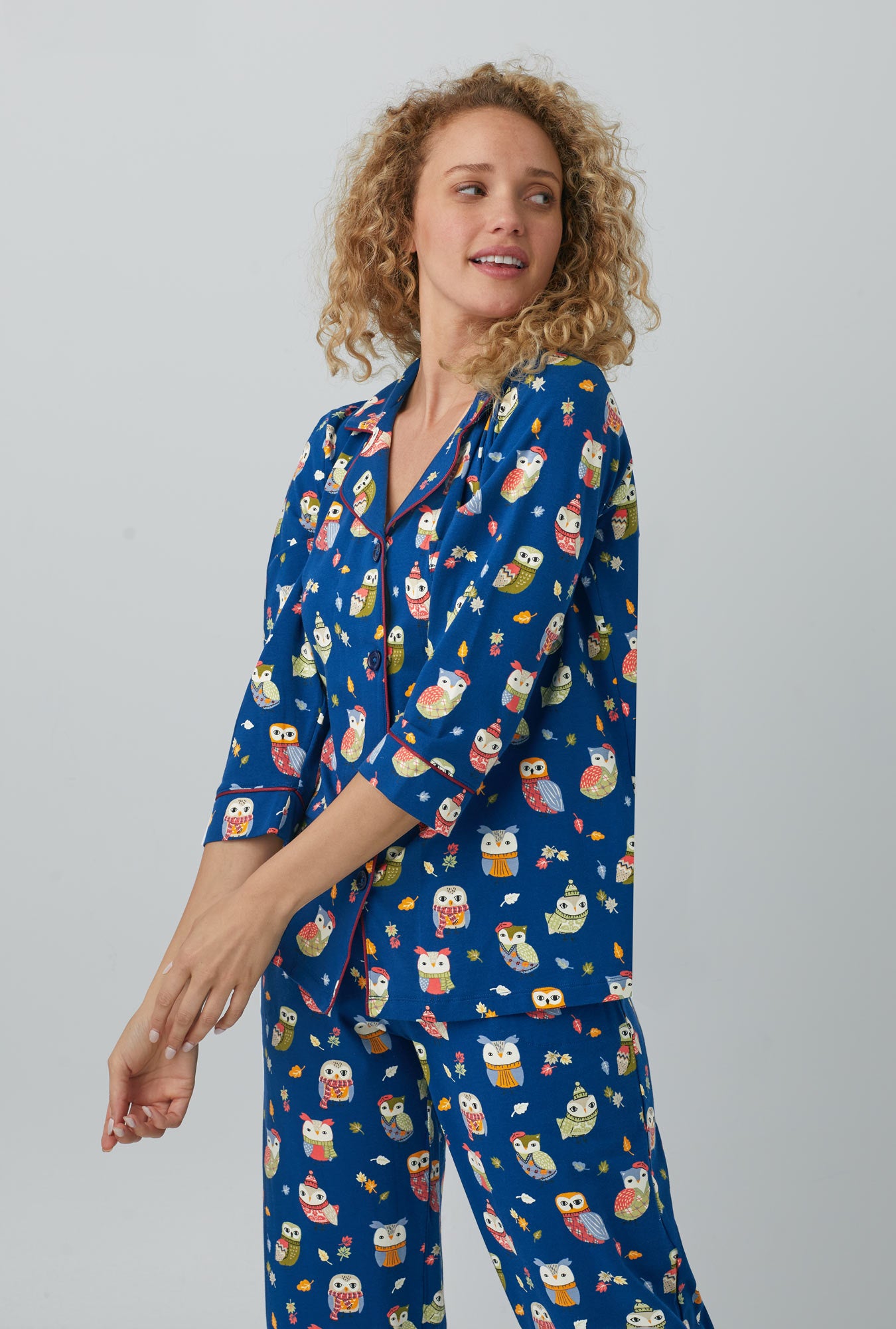 A lady wearing blue 3/4 Sleeve Classic Stretch Jersey Cropped PJ Set with autumn owls print