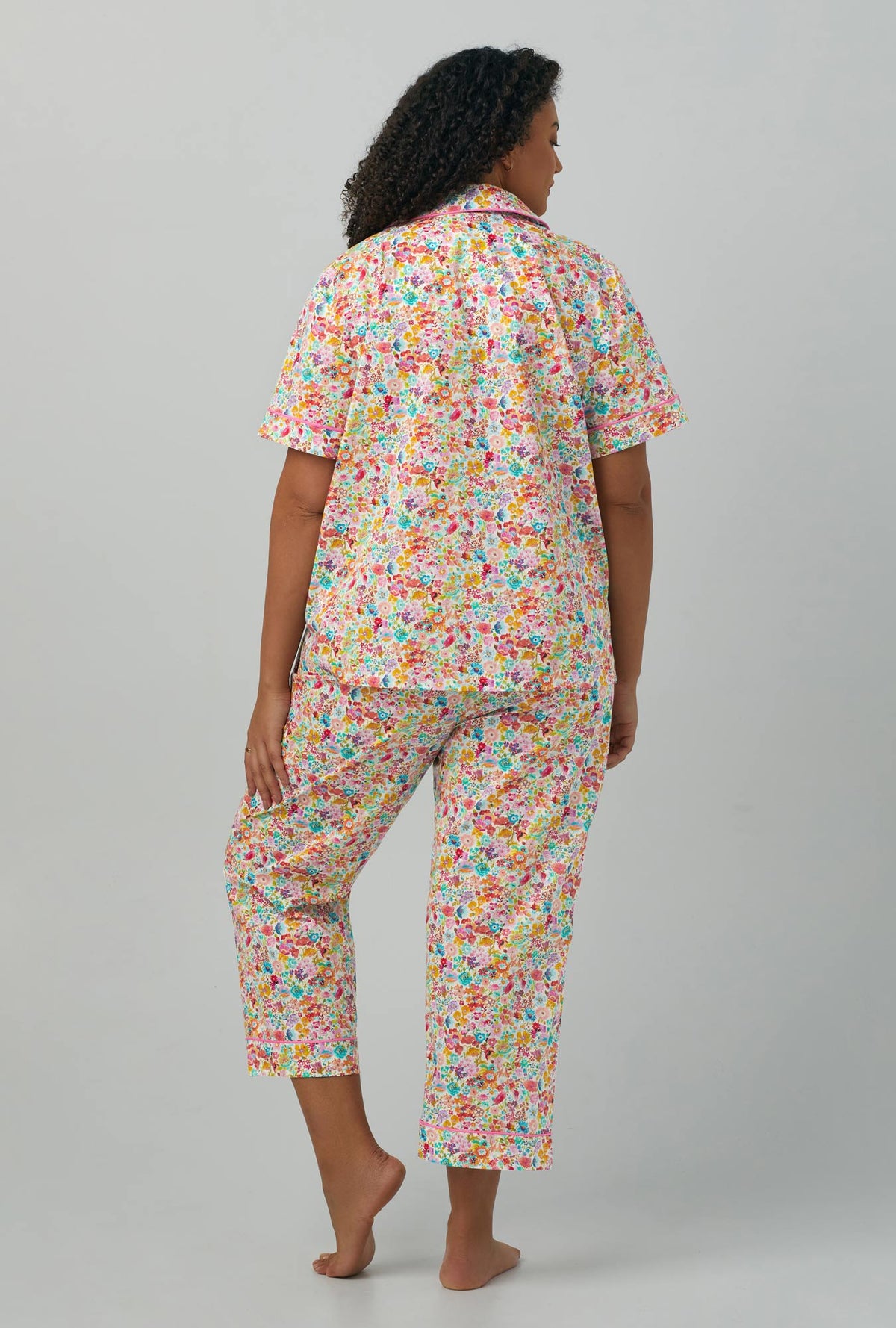 A lady wearing multi color plus size short Sleeve Classic Woven Cotton PJ Set with Classic Meadow print