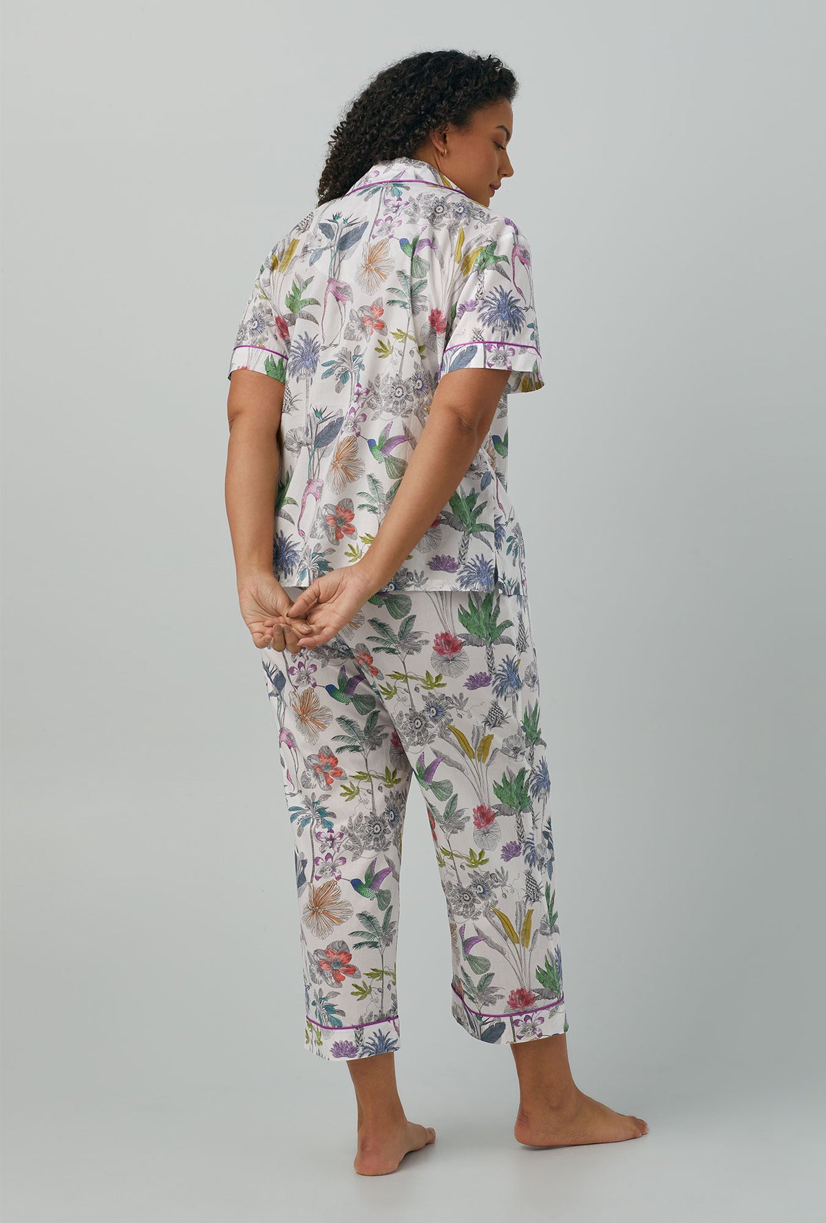 A lady wearing plus size multi color Short Sleeve Classic Woven Cotton Cropped PJ Set with Darwin&#39;s Journey print