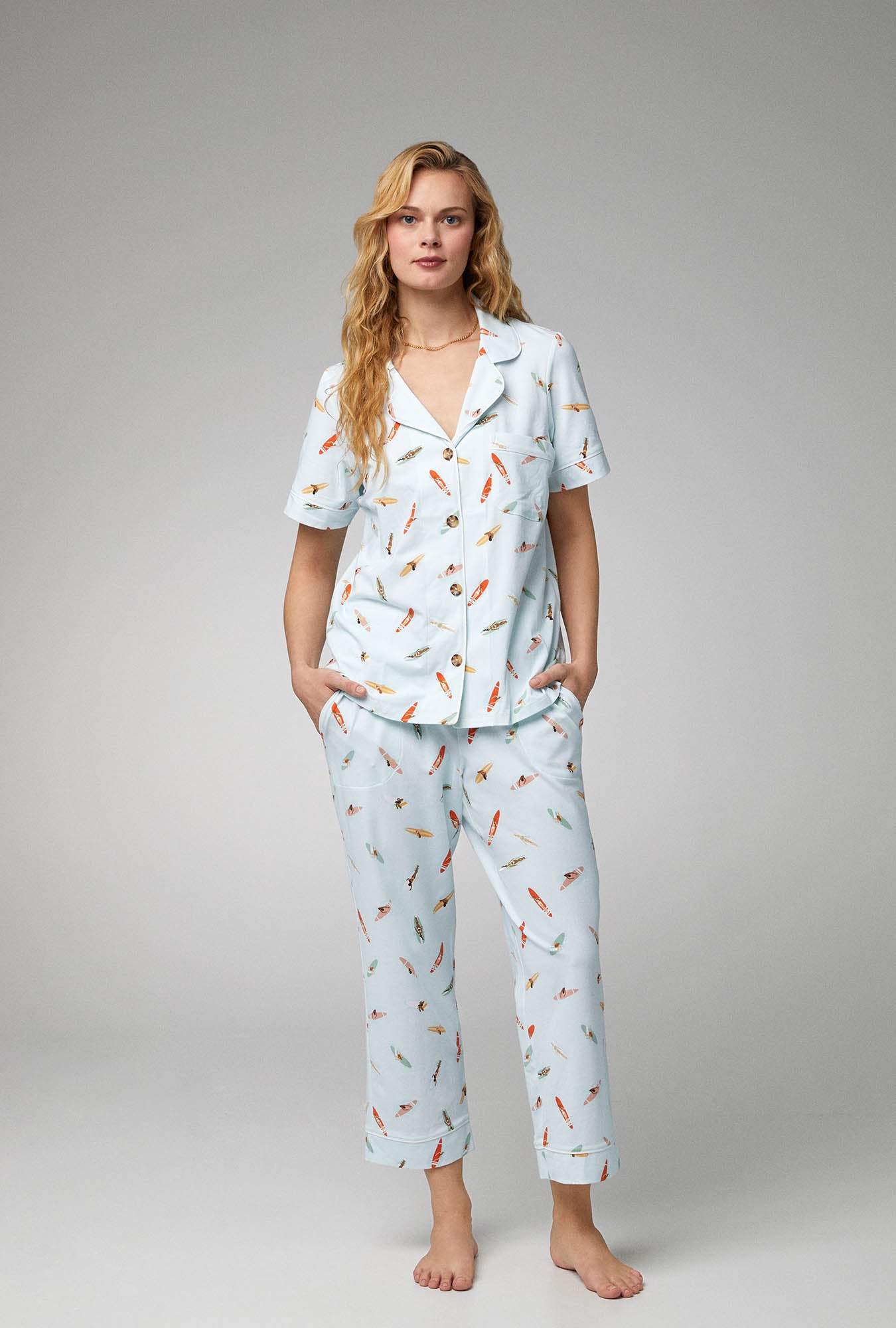 A lady wearing white short sleeve classic stretch jersey pj set with retro surf print.