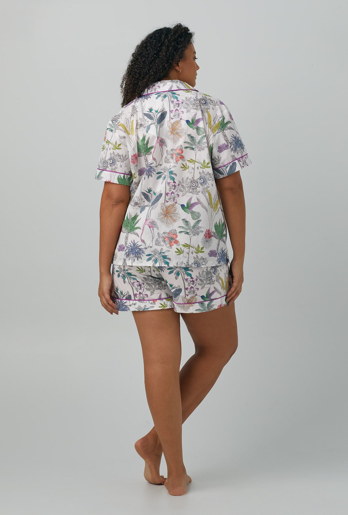 A lady wearing plus size multi color Short Sleeve Classic Woven Cotton Shorty PJ Set with Darwin&#39;s Journey print