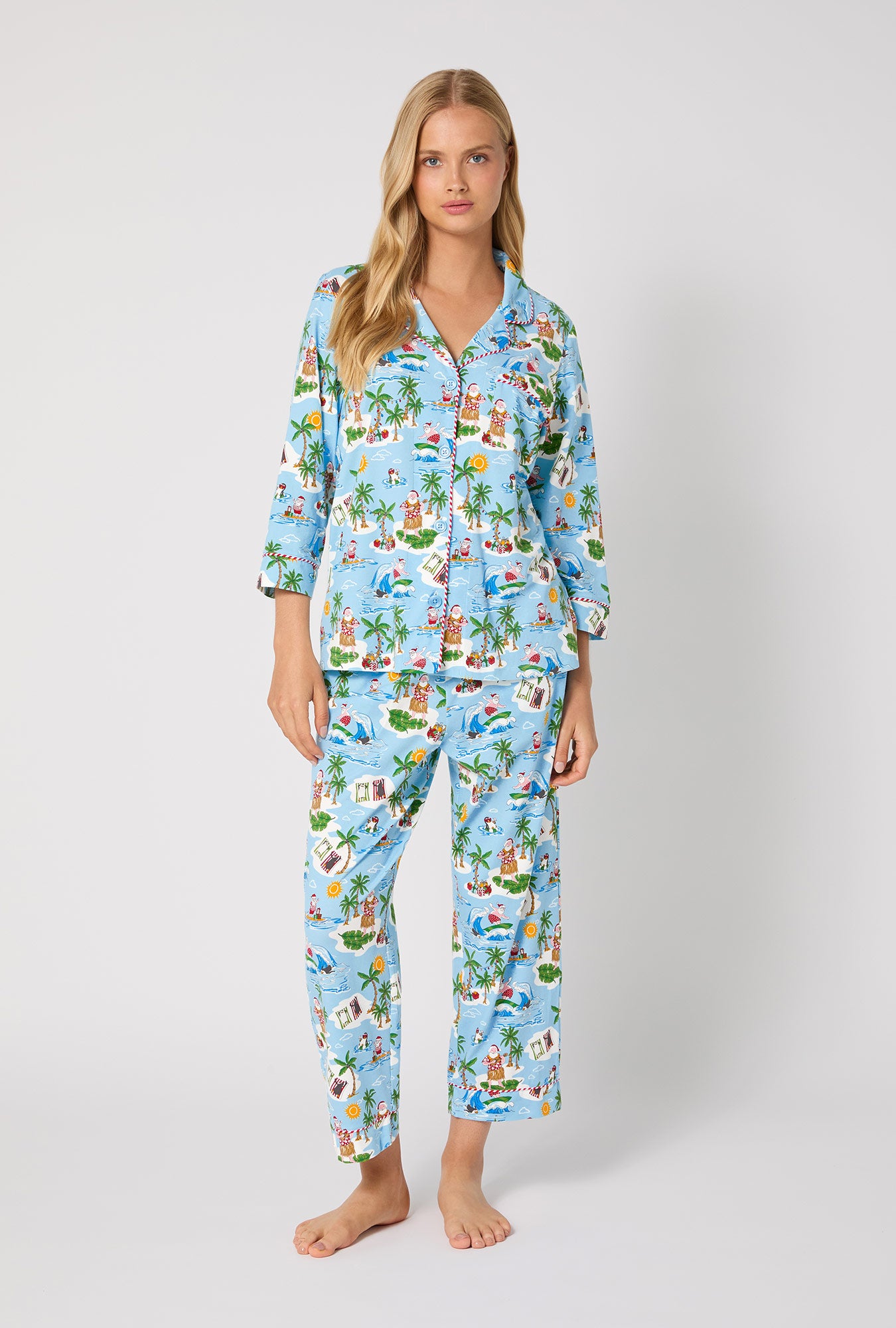A lady wearing Surfin' Santa 3/4 Sleeve Classic Stretch Jersey Cropped Pj Set