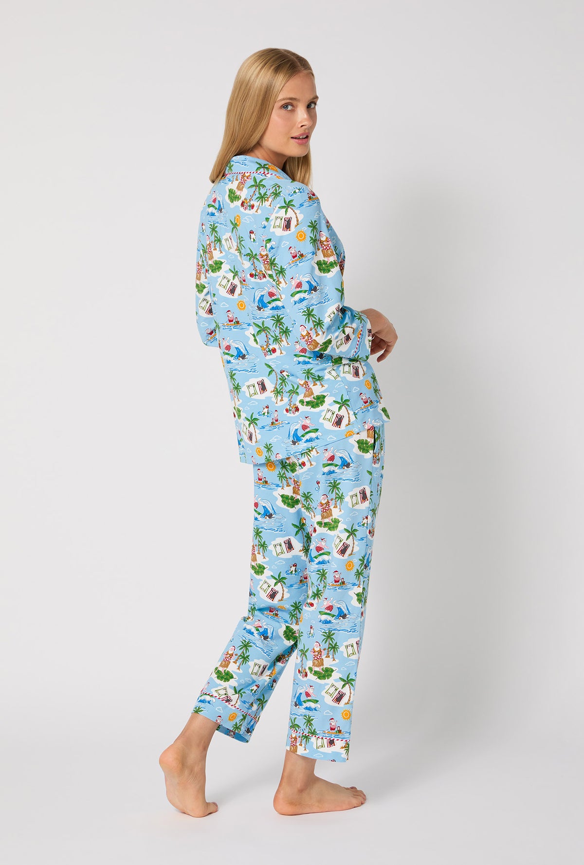 A lady wearing Surfin' Santa 3/4 Sleeve Classic Stretch Jersey Cropped Pj Set