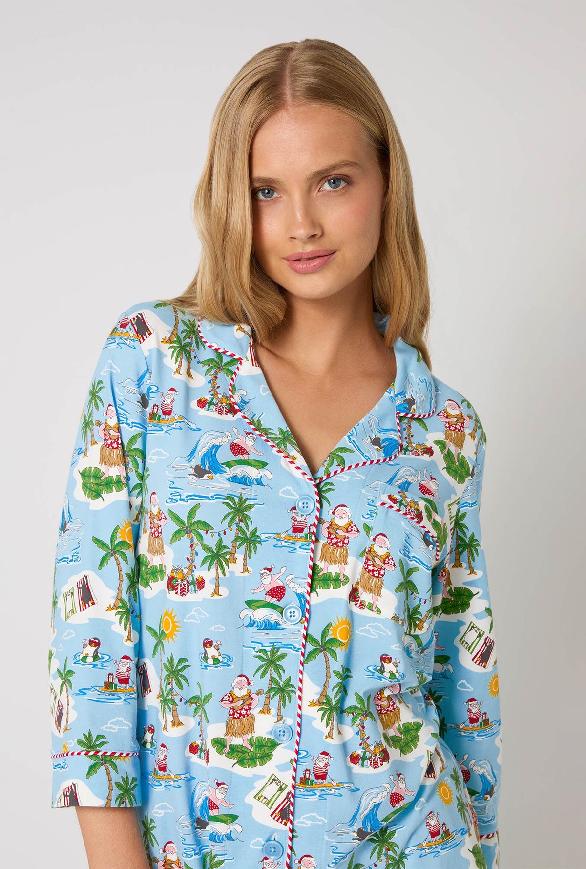 A lady wearing Surfin' Santa 3/4 Sleeve Classic Stretch Jersey Cropped Pj Set