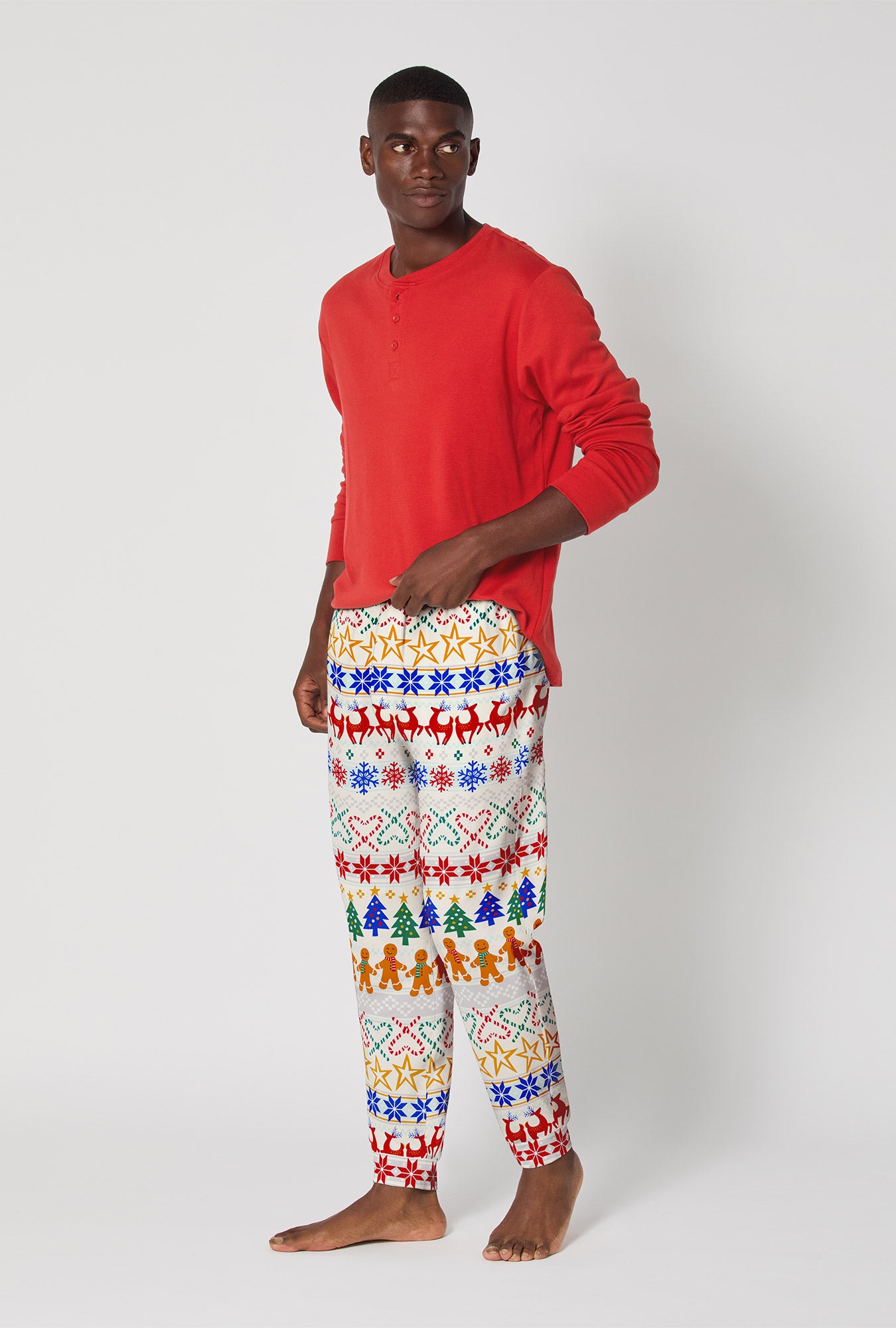 A man wearing Deck The Halls Men's Long Sleeve Henley And Jogger Stretch Jersey Pj Set