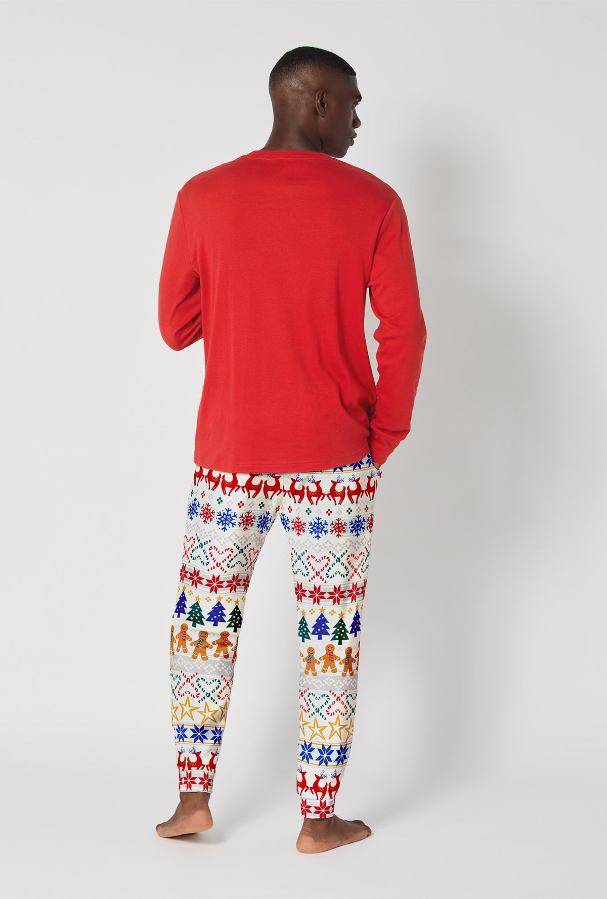 A man wearing Deck The Halls Men&#39;s Long Sleeve Henley And Jogger Stretch Jersey Pj Set