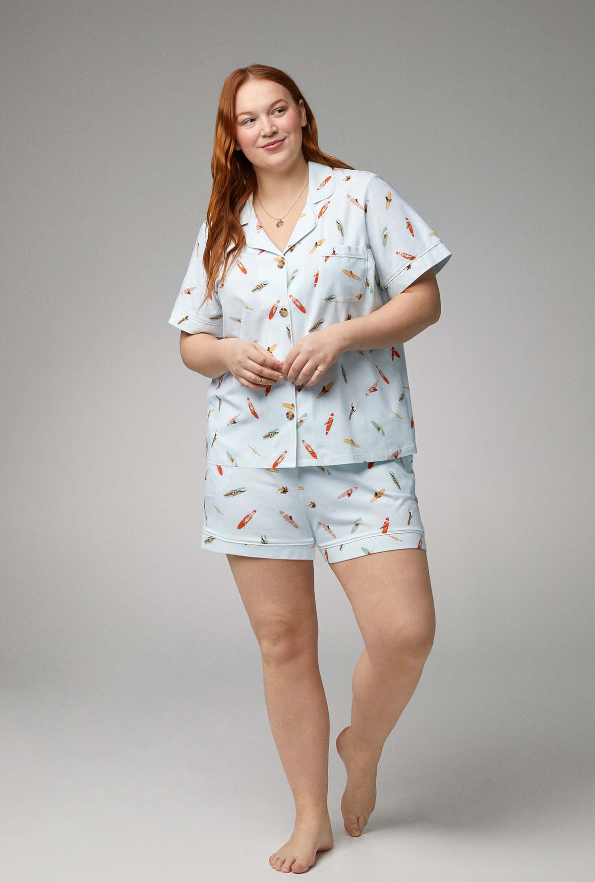A lady wearing short sleeve classic shorty stretch jersey pj set with retro surf print