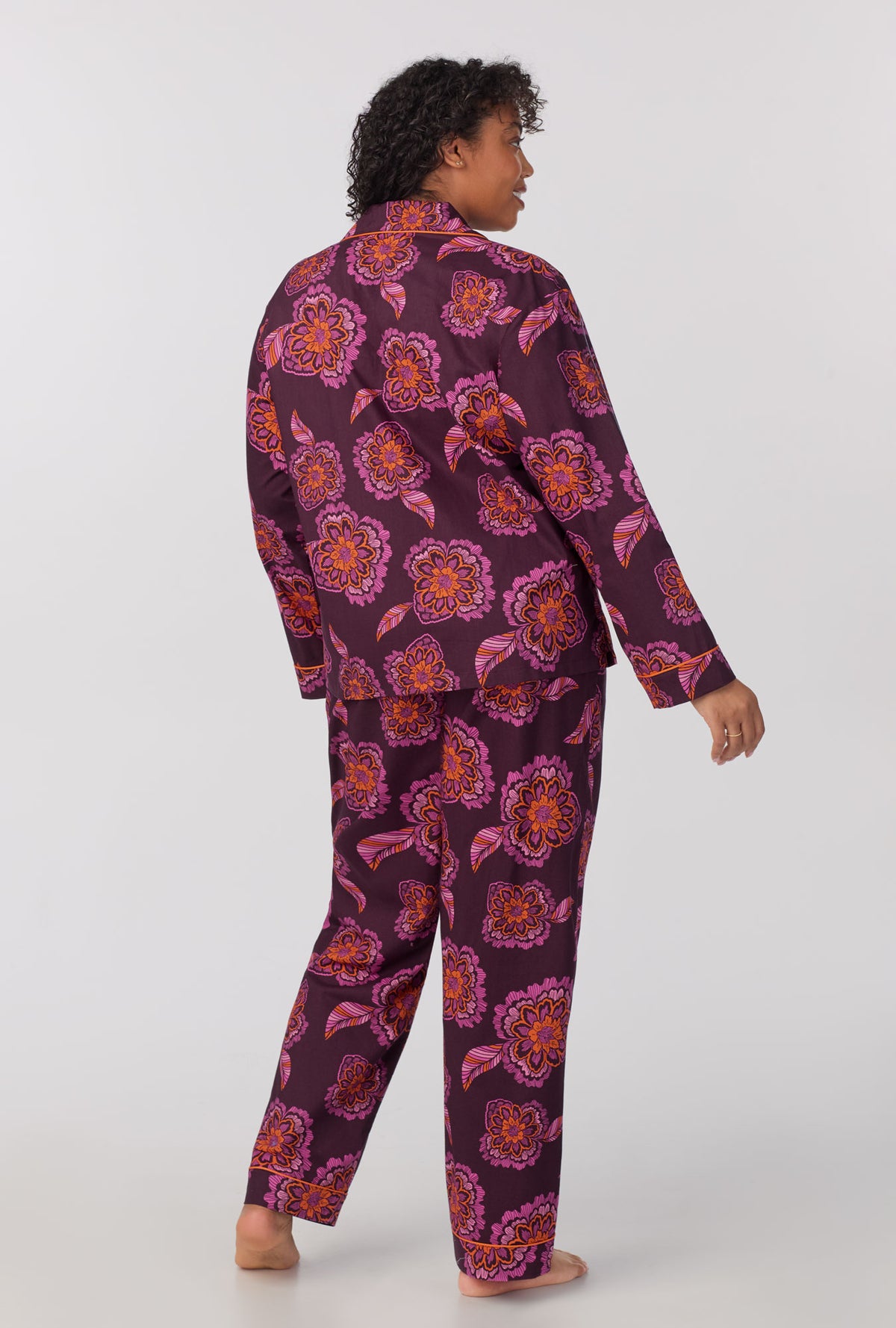 A lady wearing plus size long Sleeve Classic Woven Cotton Poplin PJ Set with African Floral print