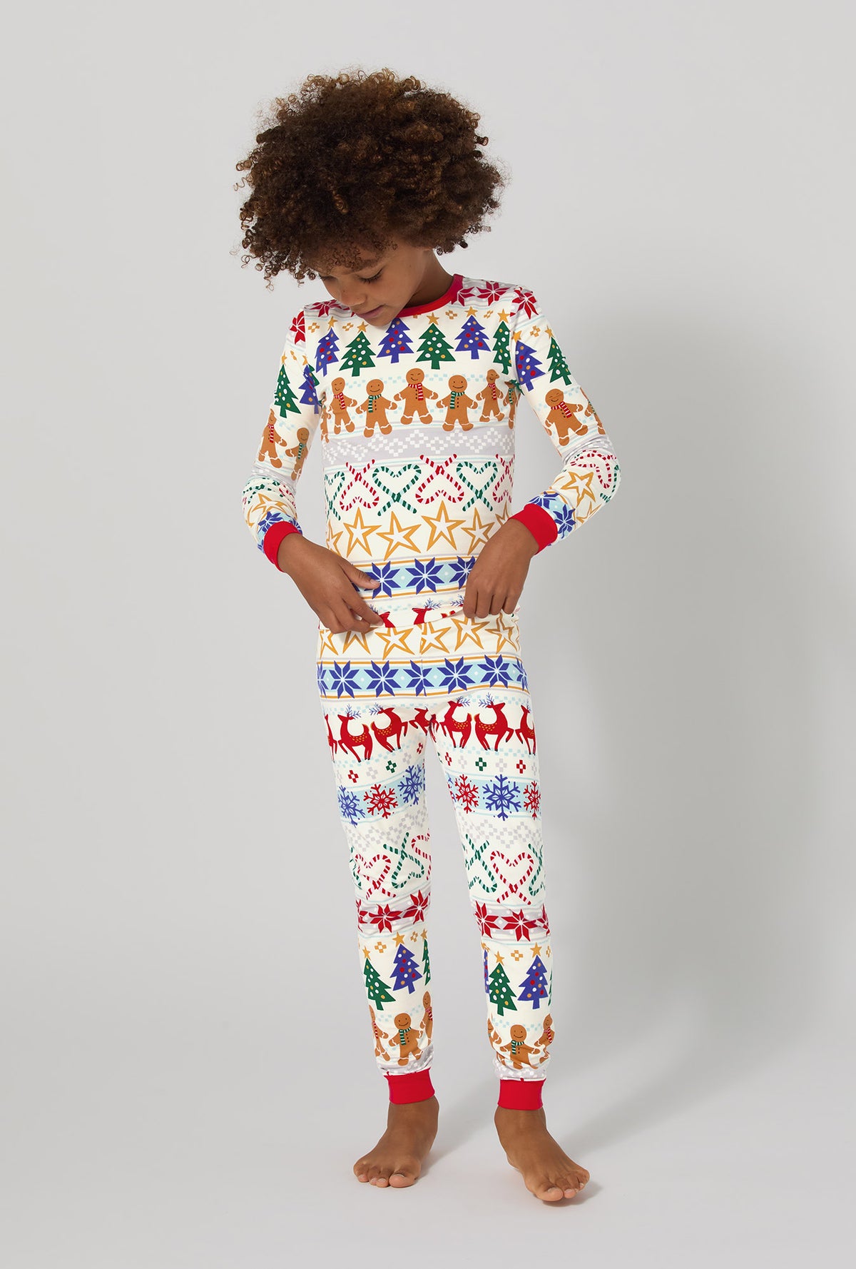 A boy wearing Deck The Halls Long Sleeve Stretch Jersey Kids Pj Set