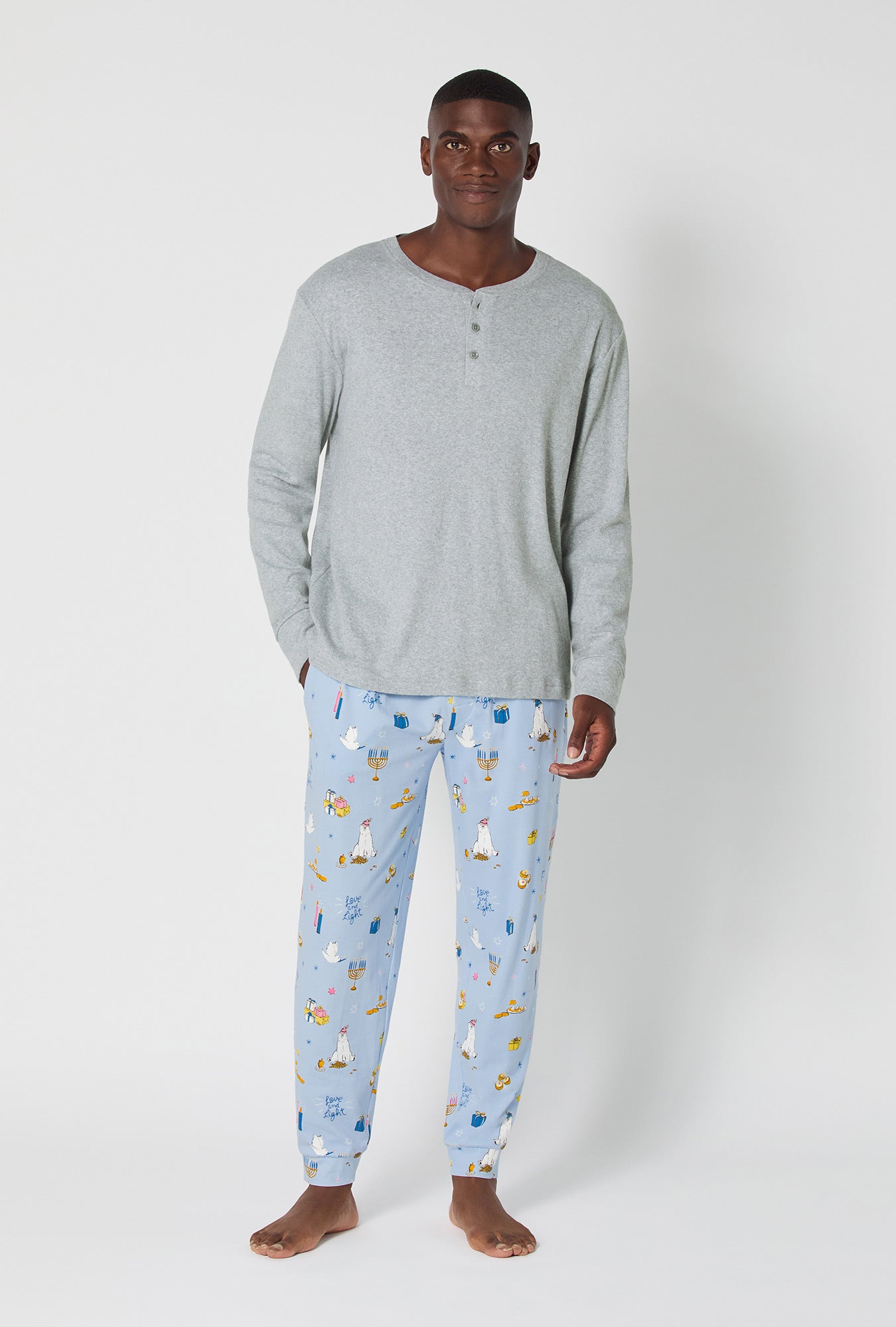 A man wearing Love And Light Men's Long Sleeve Henley And Jogger Stretch Jersey Pj Set
