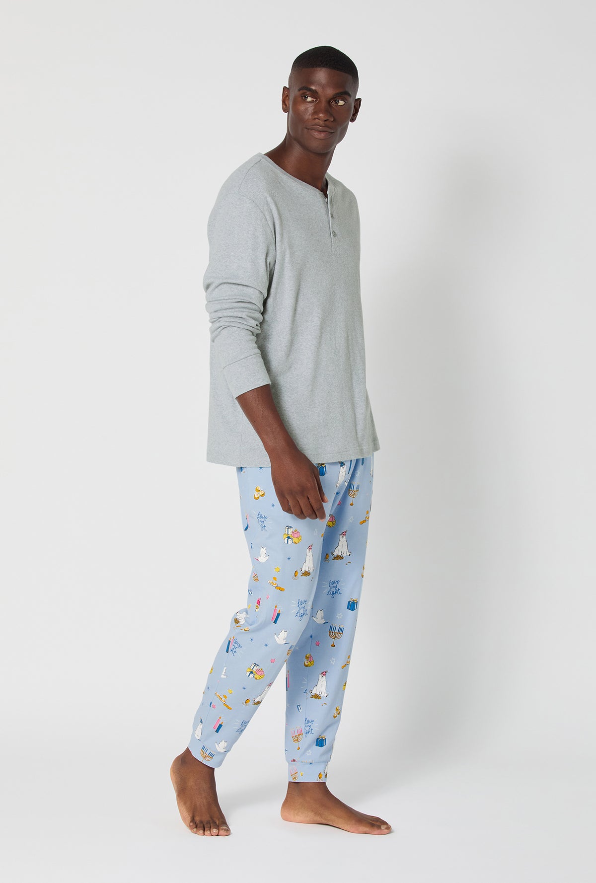A man wearing Love And Light Men&#39;s Long Sleeve Henley And Jogger Stretch Jersey Pj Set