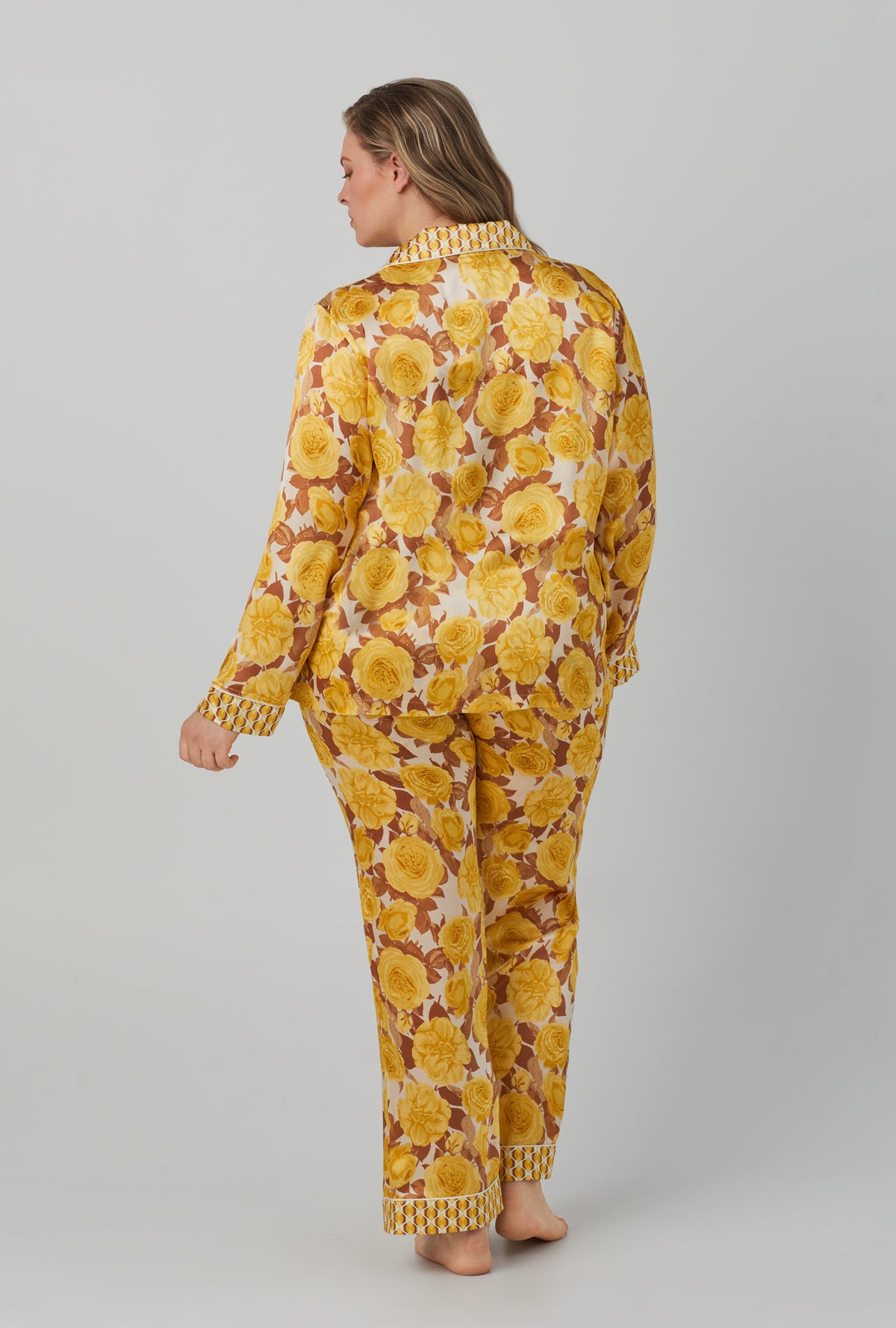 A lady wearing yellow Long Sleeve Classic Washable Silk Satin PJ Set with Golden Roses print.