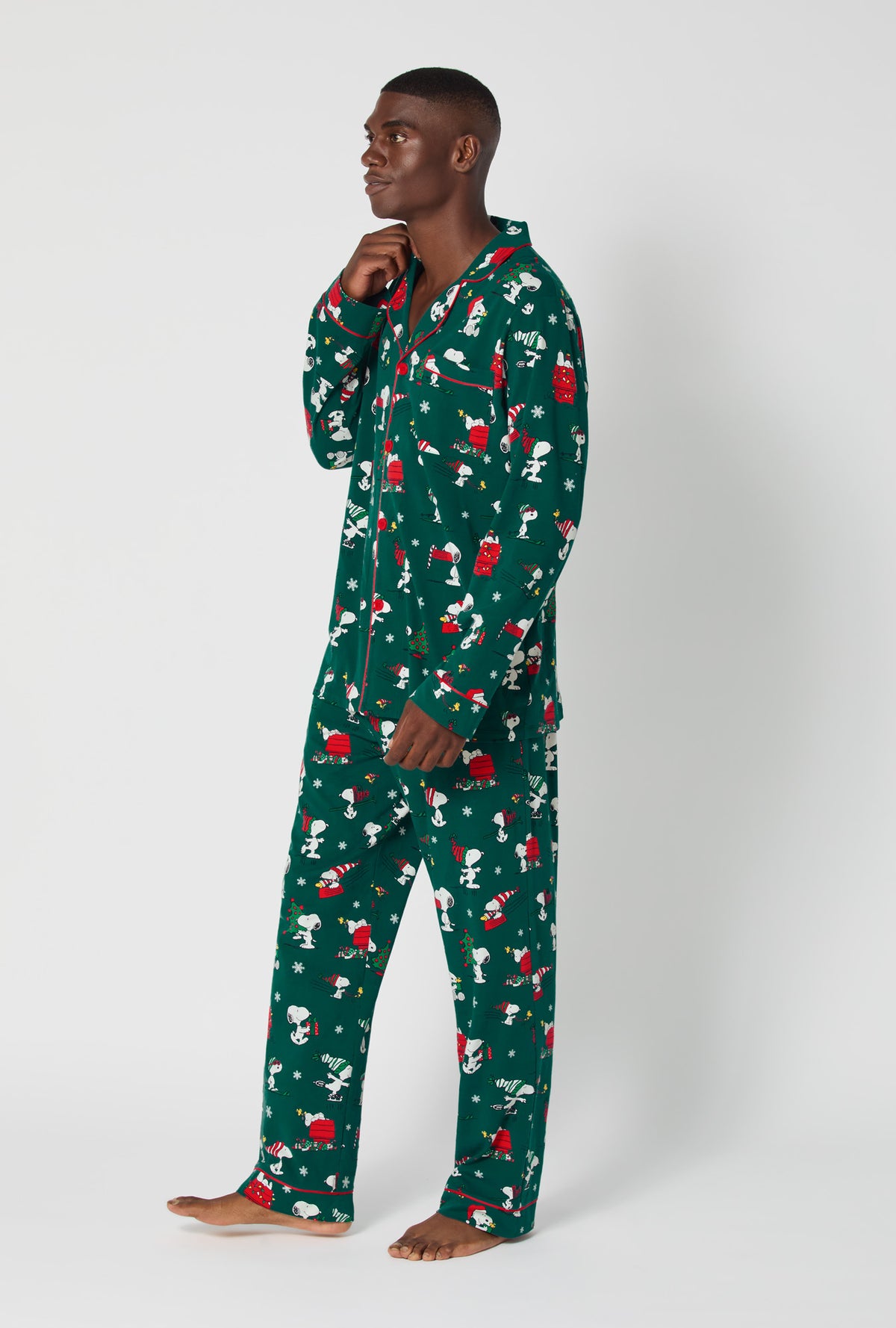 A man wearing ®Snoopy&#39;s Holiday Fun Men&#39;s Long Sleeve Classic Stretch Jersey Pj Set