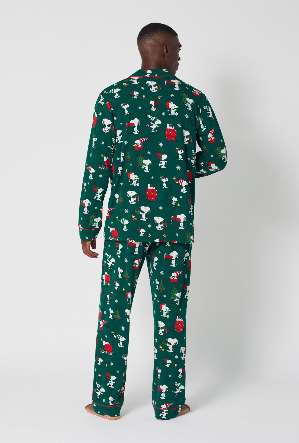 A man wearing ®Snoopy&#39;s Holiday Fun Men&#39;s Long Sleeve Classic Stretch Jersey Pj Set