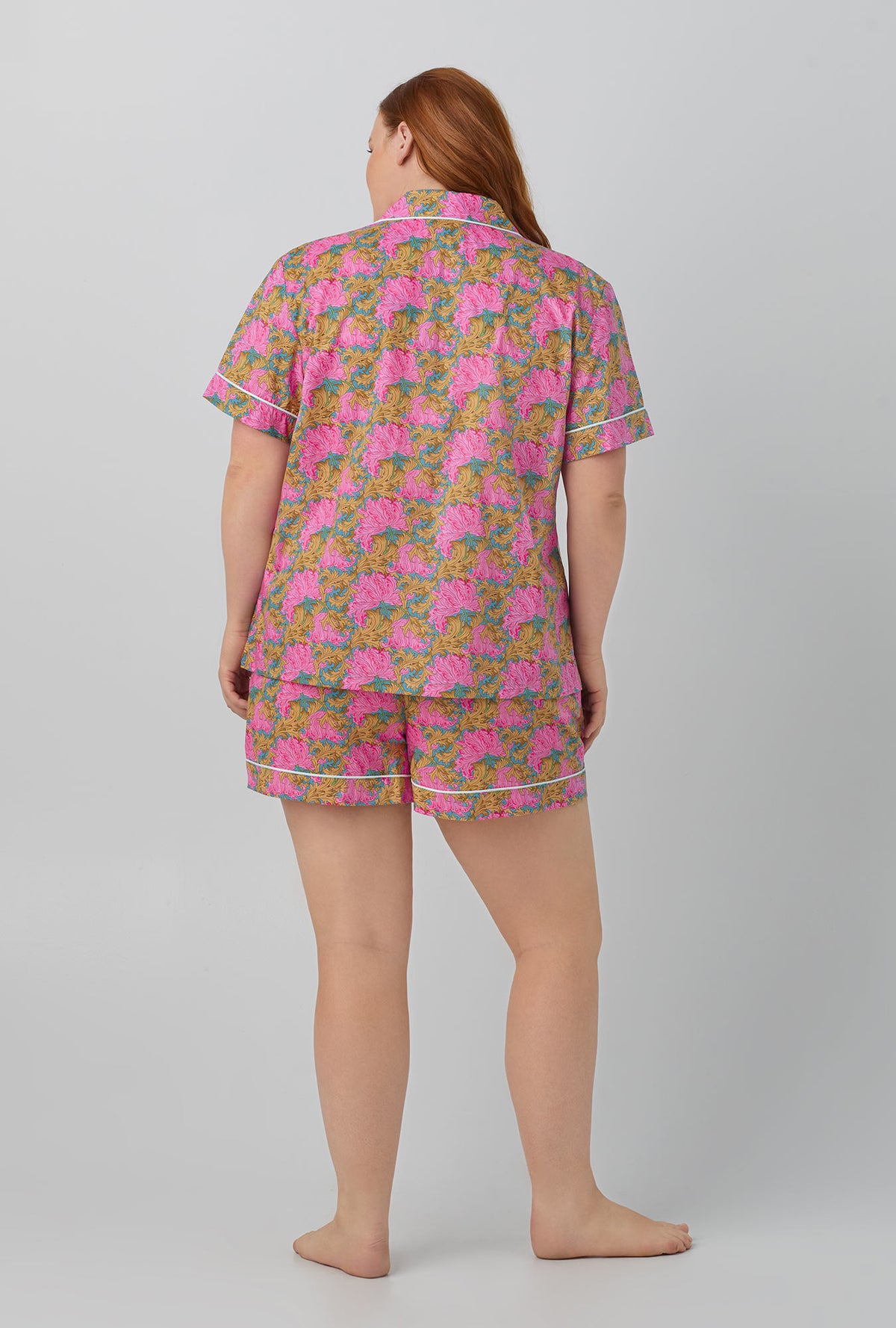 A lady wearing Follow The Sun Short Sleeve Classic Woven Cotton Tana Lawn® Shorty PJ Set Made with Liberty Fabrics