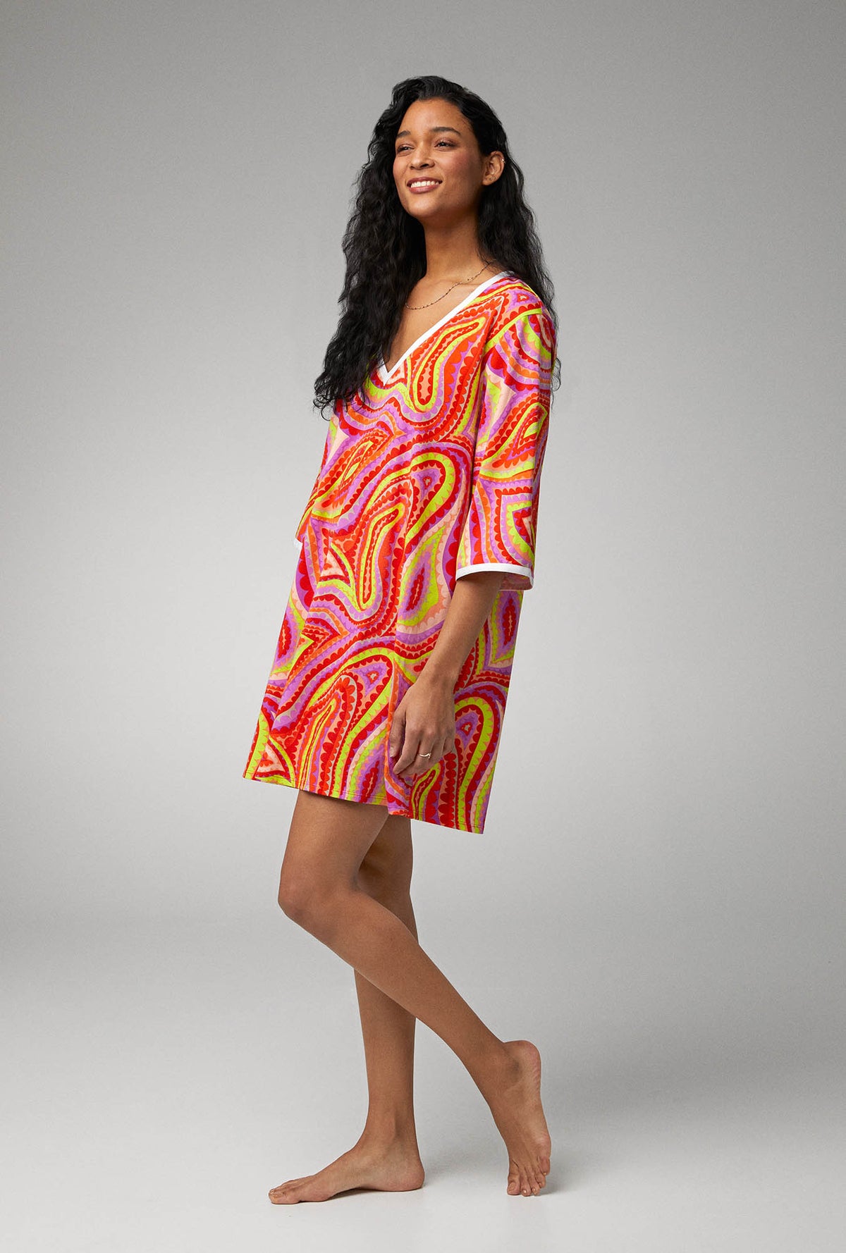 A lady wearing multi color quarter sleeve stretch jersey caftan with vivacious print.