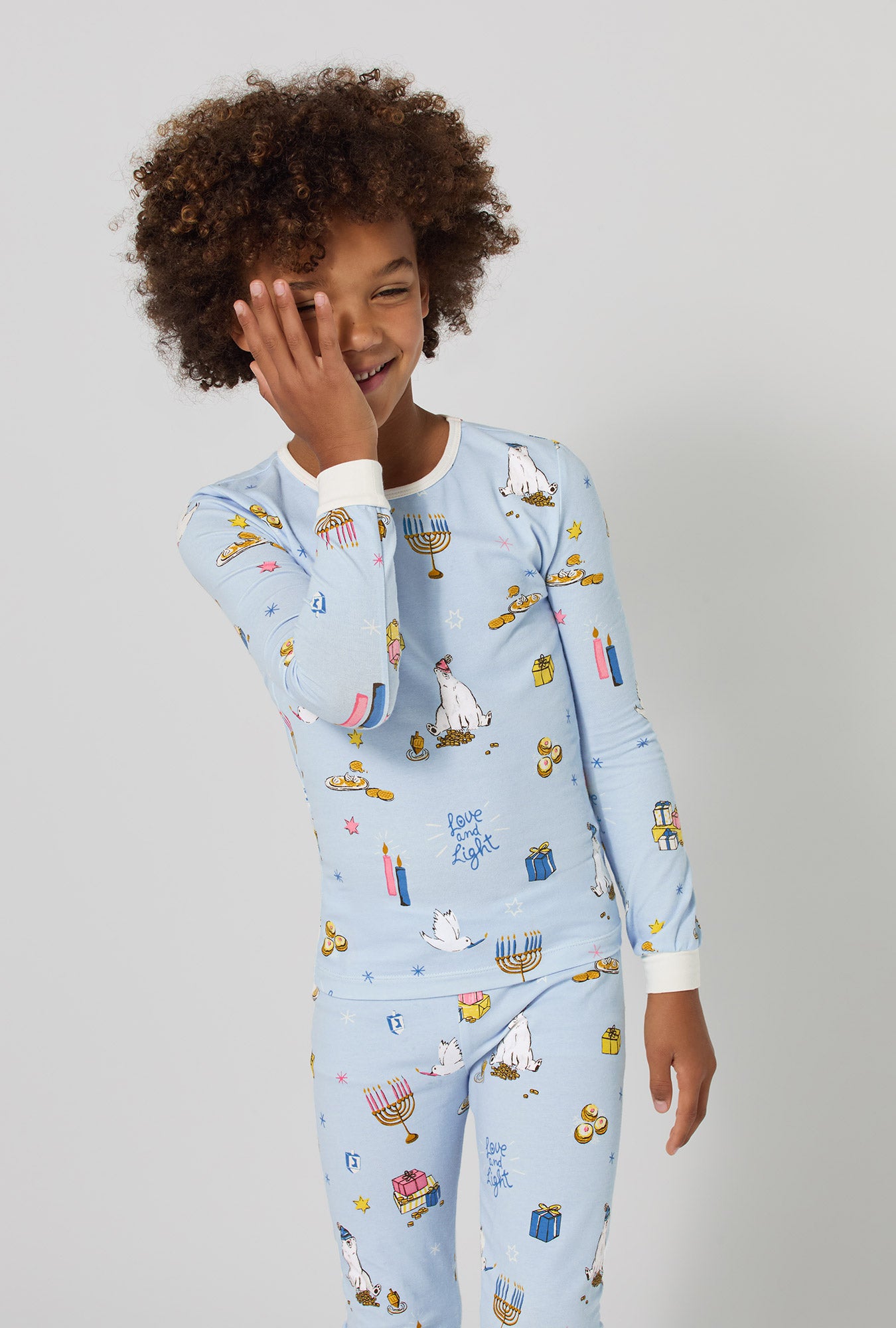 A girl wearing Love And Light Long Sleeve Stretch Jersey Kids Pj Set