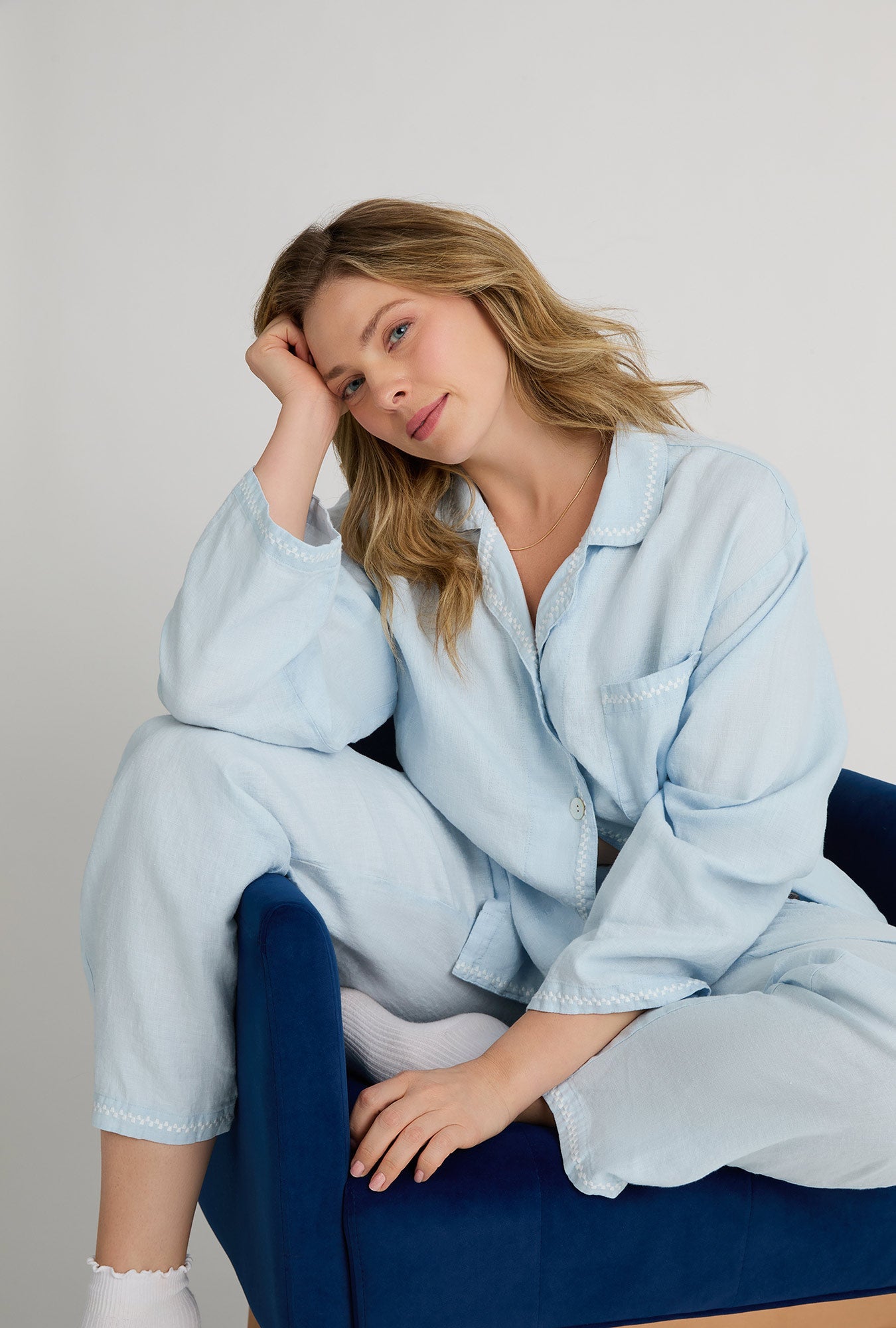 A closeup of A lady wearing plus size Baby's Breath Blue Long Sleeve Classic Woven Linen Pj Set