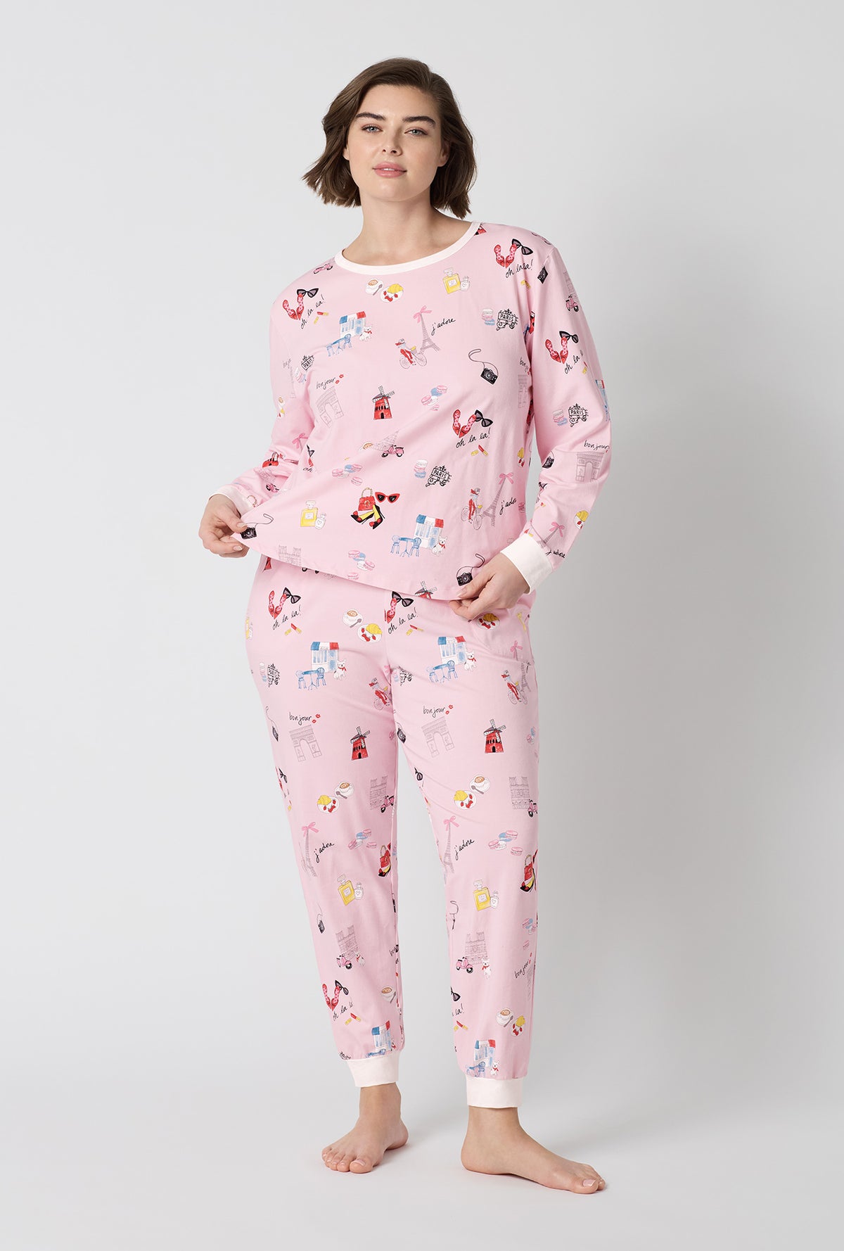 A Lady Wearing Plus Size J'adore Paris Long Sleeve Pullover Crew And Jogger Stretch Jersey Pj Set