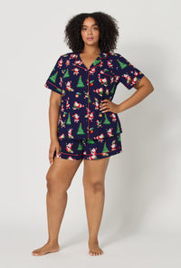 A lady wearing plus size Santa's Night Out Short Sleeve Classic Shorty Stretch Jersey Pj Set