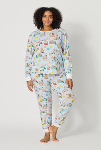 A lady wearing plus size Gingerbread City Long Sleeve Pullover Crew And Jogger Stretch Jersey Pj Set