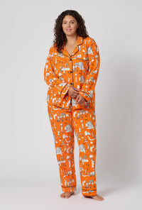 A Lady Wearing Plus Size Orange Spooky In The City Long Sleeve Classic Stretch Jersey Pj Set