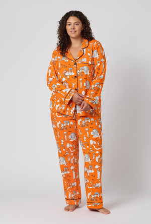 A Lady Wearing Plus Size Orange Spooky In The City Long Sleeve Classic Stretch Jersey Pj Set