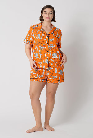 A Lady Wearing Plus Size Orange Spooky In The City Short Sleeve Classic Shorty Stretch Jersey Pj Set