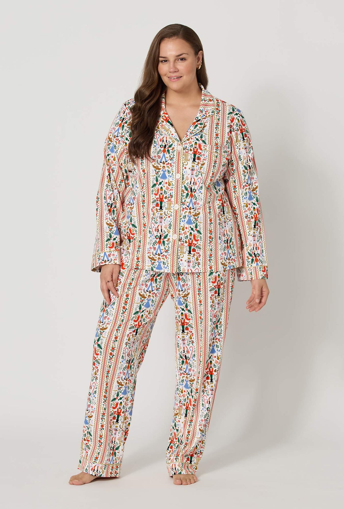 A lady wearing  plus size Rifle Paper Co. x BedHead PJs Holly Jolly Nutcracker Long Sleeve Classic Stretch Jersey Pj Set