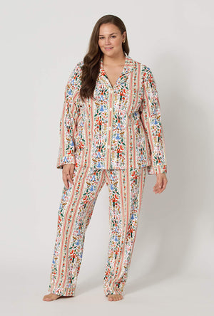 A lady wearing  plus size Rifle Paper Co. x BedHead PJs Holly Jolly Nutcracker Long Sleeve Classic Stretch Jersey Pj Set