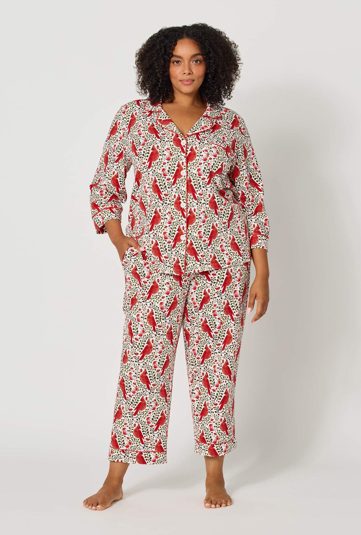 A lady wearing plus size Rifle Paper Co. x BedHead PJs Cardinals 3/4 Sleeve Classic Stretch Jersey Cropped Pj Set