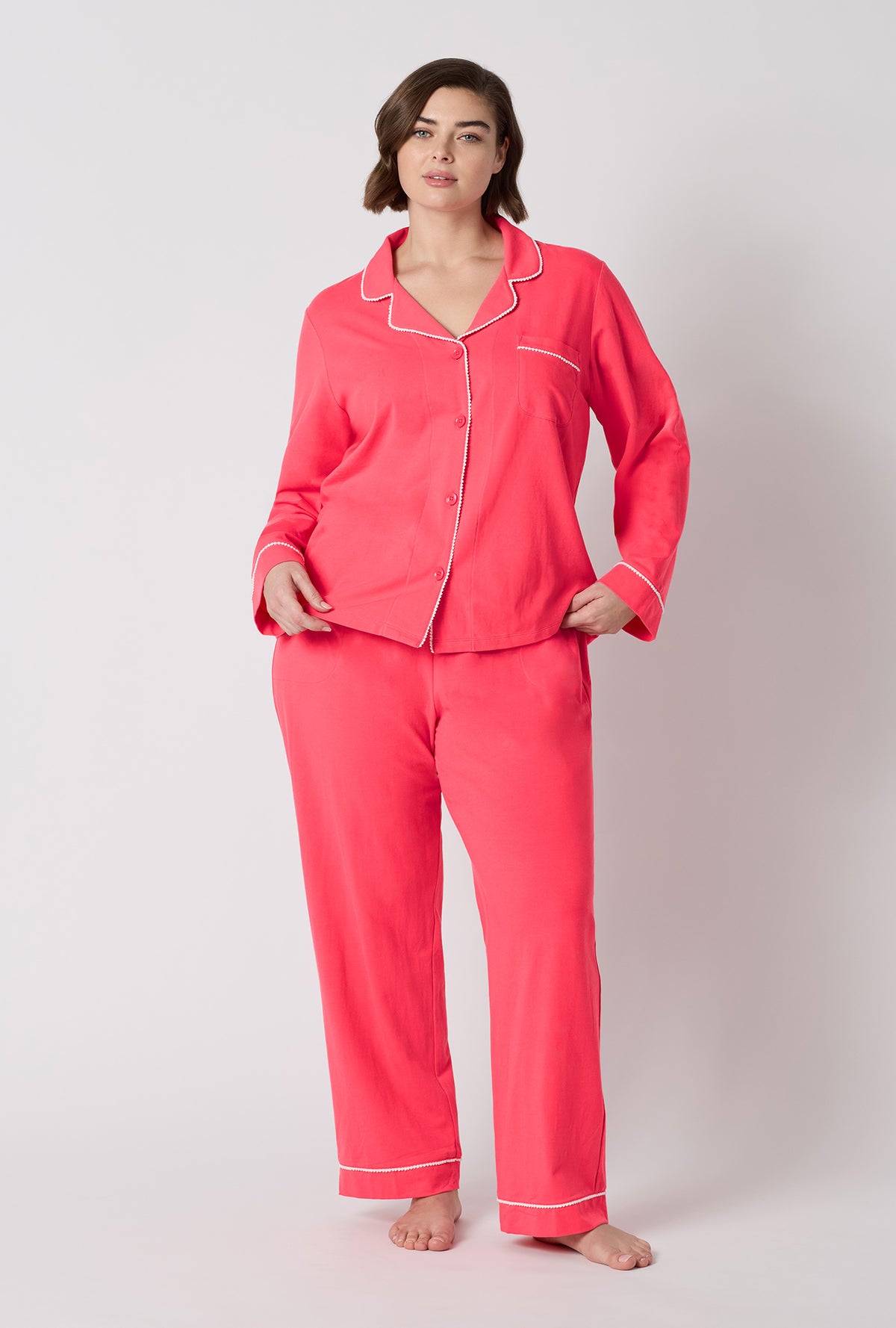 A lady wearing plus size Coral Red Long Sleeve Classic Stretch Jersey Pj Set