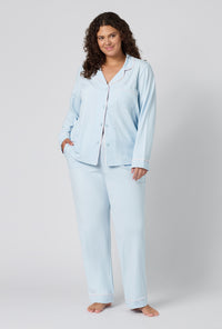 A lady wearing plus size Blissful Blue Long Sleeve Classic Stretch Jersey Pj Set 
