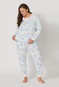 A lady wearing plus size Winter Wonderland Long Sleeve Pullover Crew And Jogger Stretch Jersey Pj Set