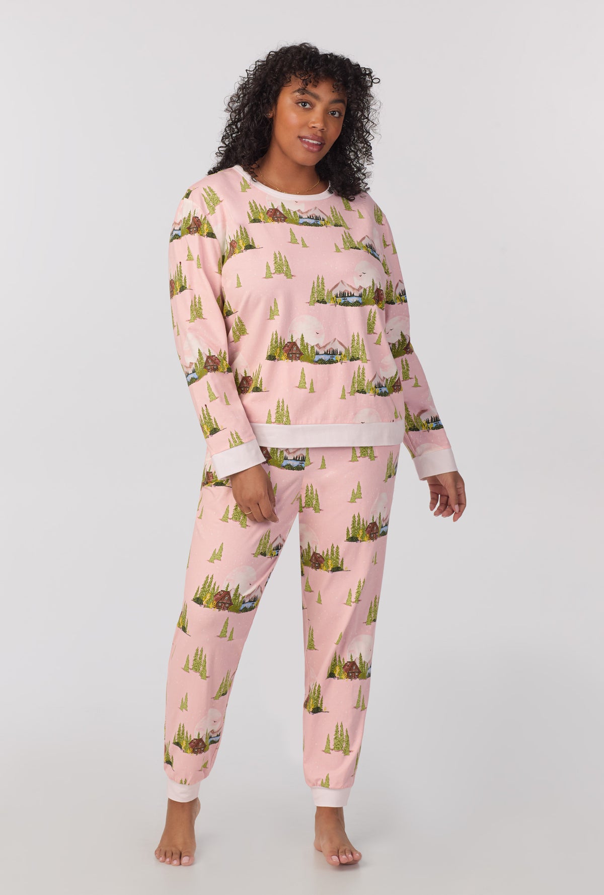 A lady wearing Long Sleeve Pullover Crew and Jogger Stretch Jersey PJ Set with Pine Lake print  